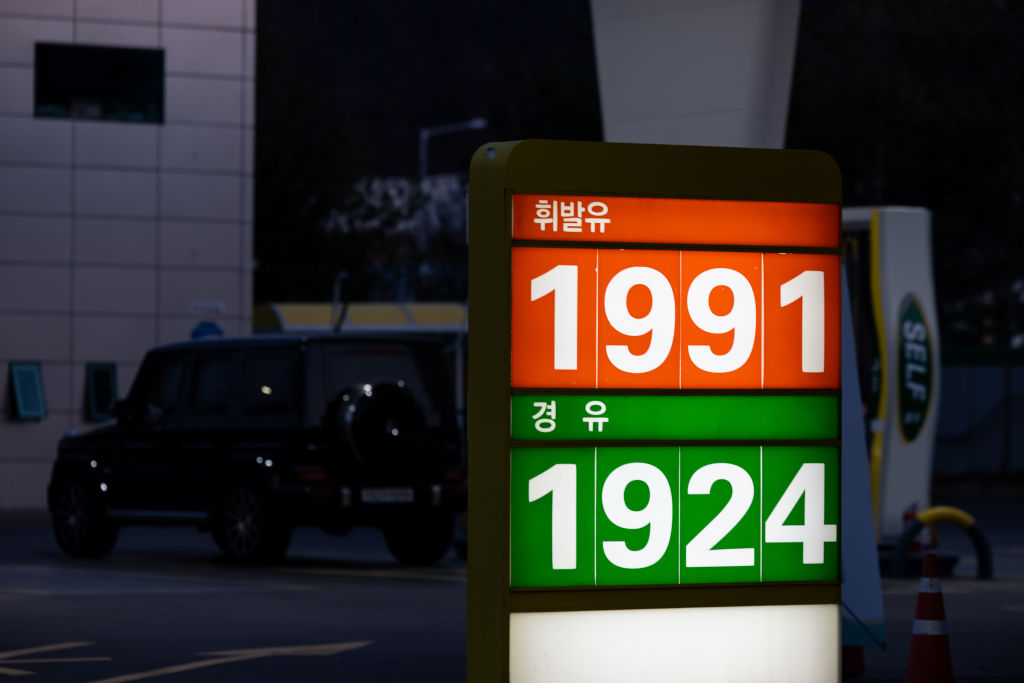 A sign displays fuel prices at a gas station in Gimpo, South Korea, on April 3, 2022. South Korea has extended a reduction in fuel taxes for another three months through July to rein in inflation. (SeongJoon Cho/Bloomberg via Getty Images)