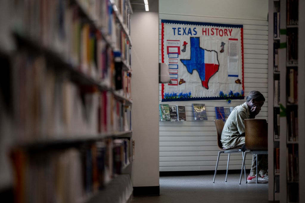 A person sits in the Houston Public Library on April 26, 2022 in Houston, Texas. A group of local residents is suing Llano County in federal court for the County's removal and censorship of library books addressing racism and LGBTQ issues. The lawsuit addresses 