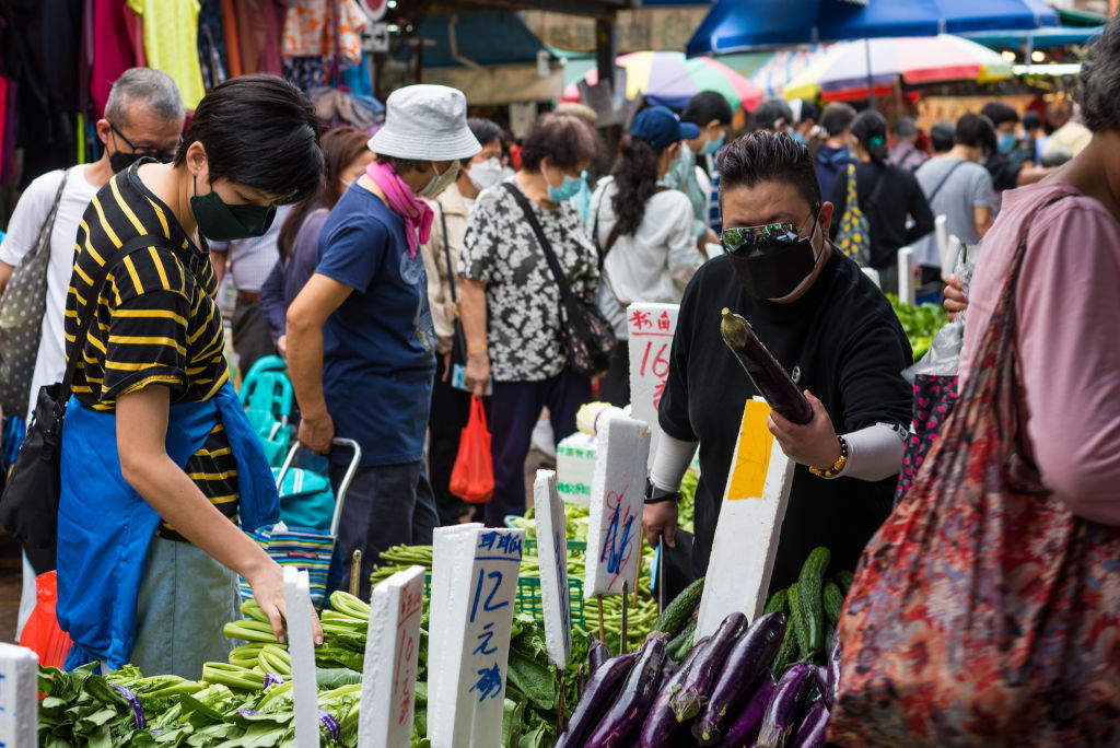 Customers examine fresh vegetables in Ngau Chi Wan market, in Hong Kong, China, on March 22, 2022. (Marc Fernandes—NurPhoto/Getty Images)