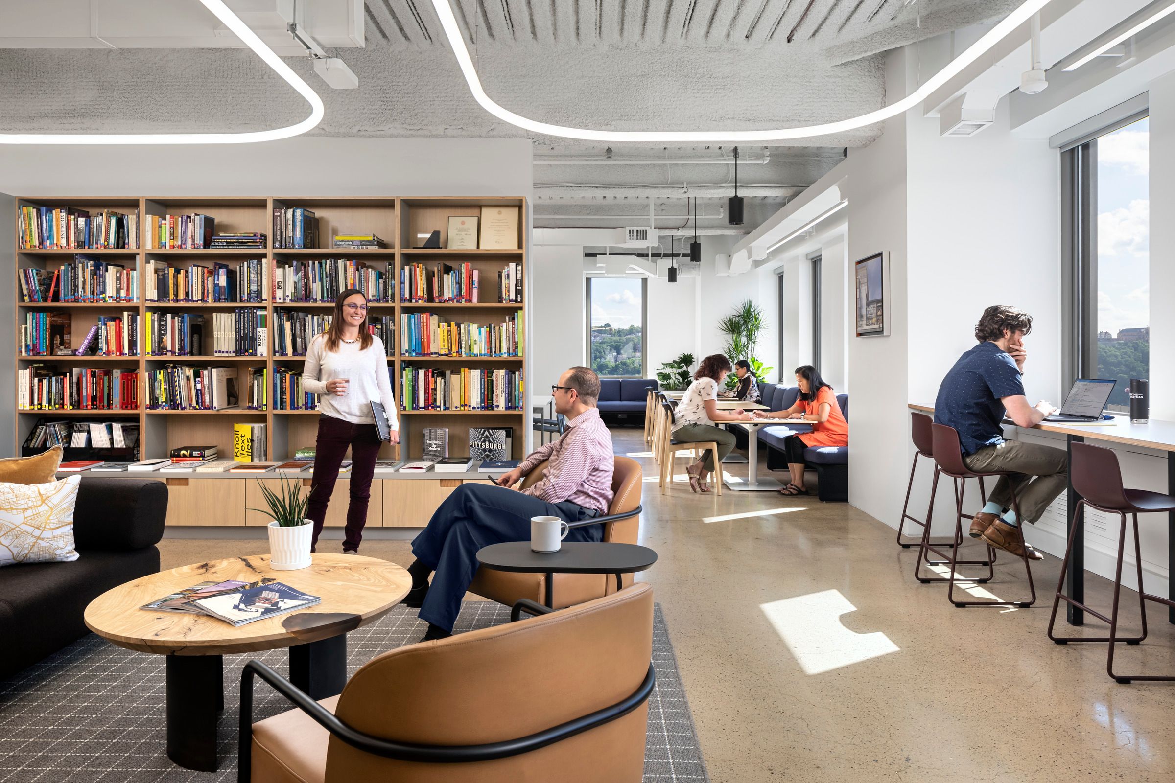 By mixing a variety of furniture and floor plans, Perkins Eastman has created workspaces that might recall a living room, a kitchen counter, or even a neighborhood cafe. (Andrew Rugge / Courtesy Perkins Eastman)
