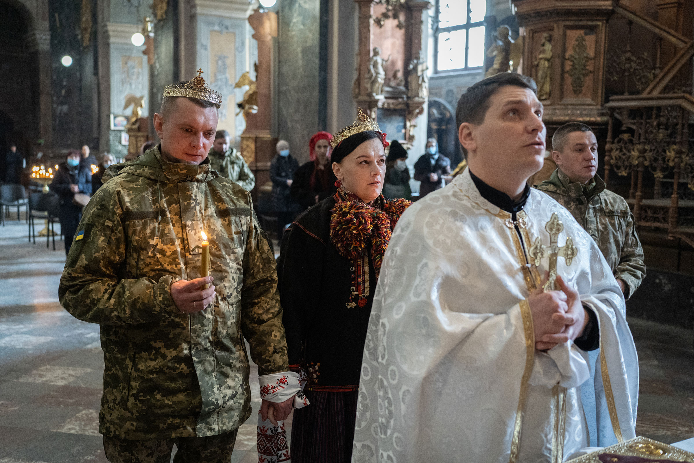 Roman, 33, soldier of the 103 Brigade of the Armed Forces of Ukraine, marries Iryna, 37, in the Garrison Temple in Lviv, on March 1. They also baptized their child, Solomiya. (Serhii Korovainyi)