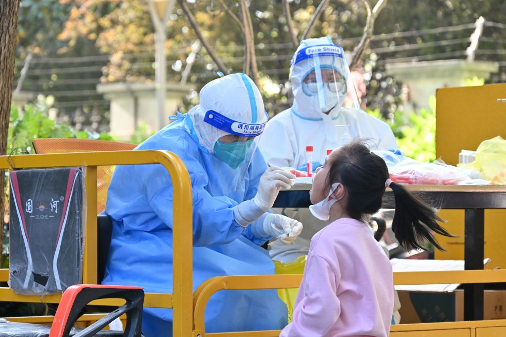 A little girl gets tested for the COVID-19 in a residential block in Shanghai, China Saturday, April 9, 2022. (Shen Chunchen–Future Publishing/Getting Images)