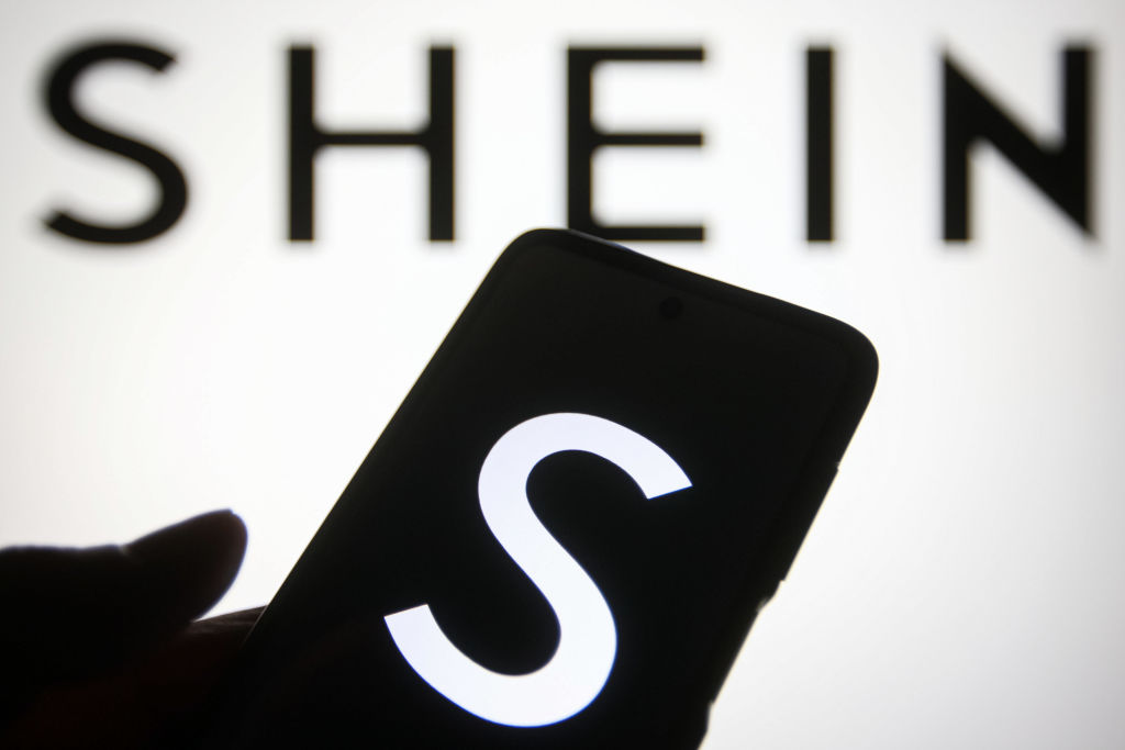 In this photo illustration a Shein logo of a Chinese online fashion and sports retailer is seen on a smartphone and a pc screen (Pavlo Gonchar—SOPA Images/LightRocket/ Getty Images)