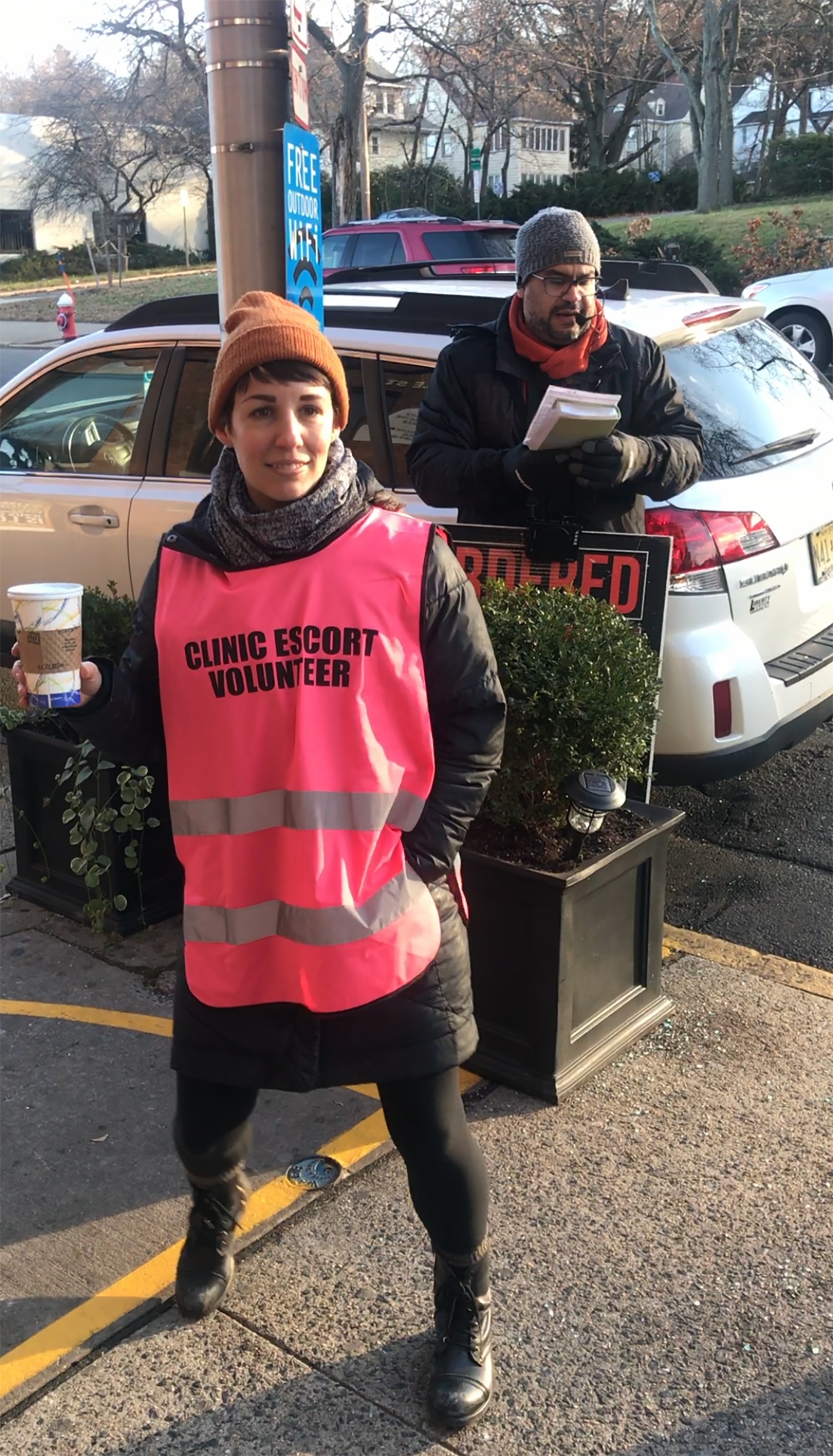 Photograph of the author in front of an anti-abortion protester at Metropolitan Medical Associates in Englewood, N.J., in December 2019 (Courtesy Lauren Rankin)