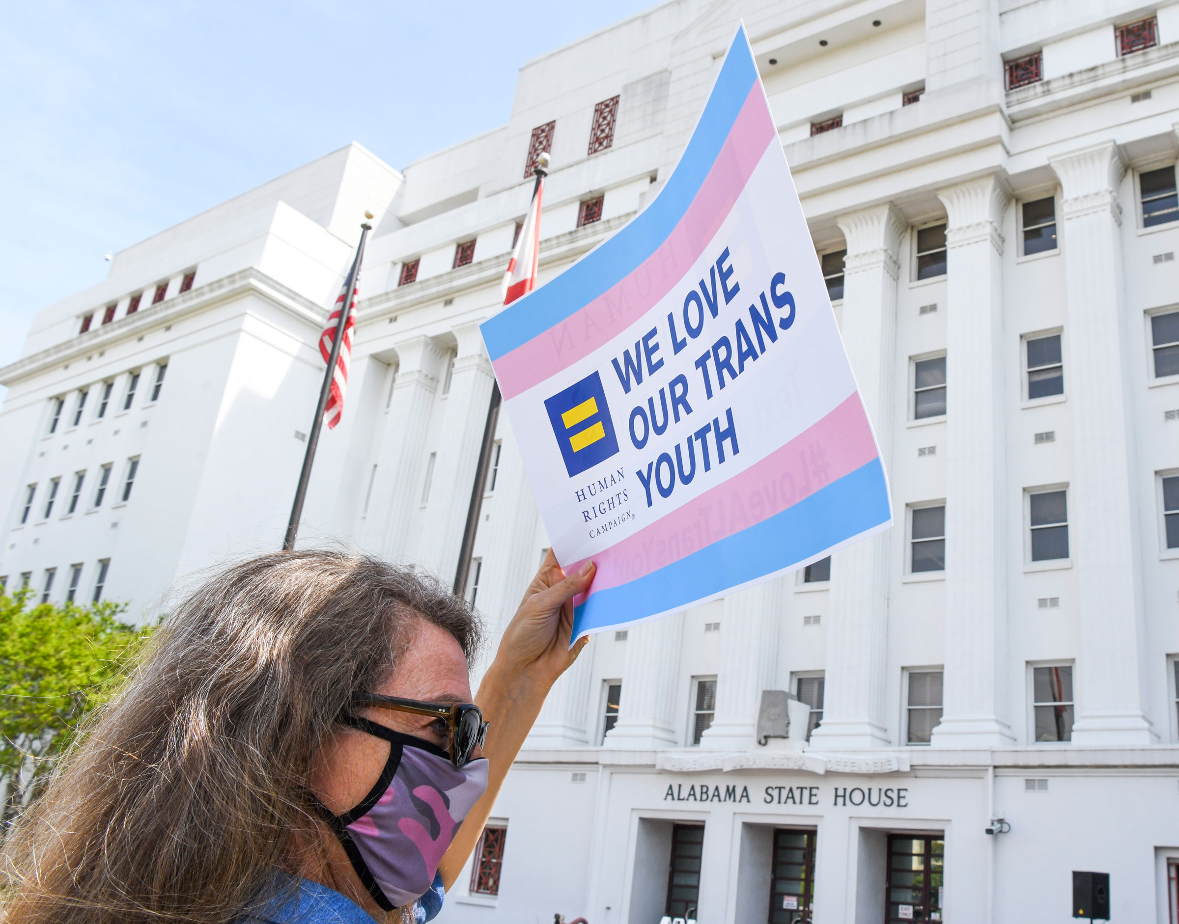 Jodi Womack holds a sign that reads "We Love Our Trans Youth" during a rally at the Alabama State House to draw attention to anti-transgender legislation introduced in Alabama on March 30, 2021 in Montgomery, Alabama. (Julie Bennett—Getty Images)