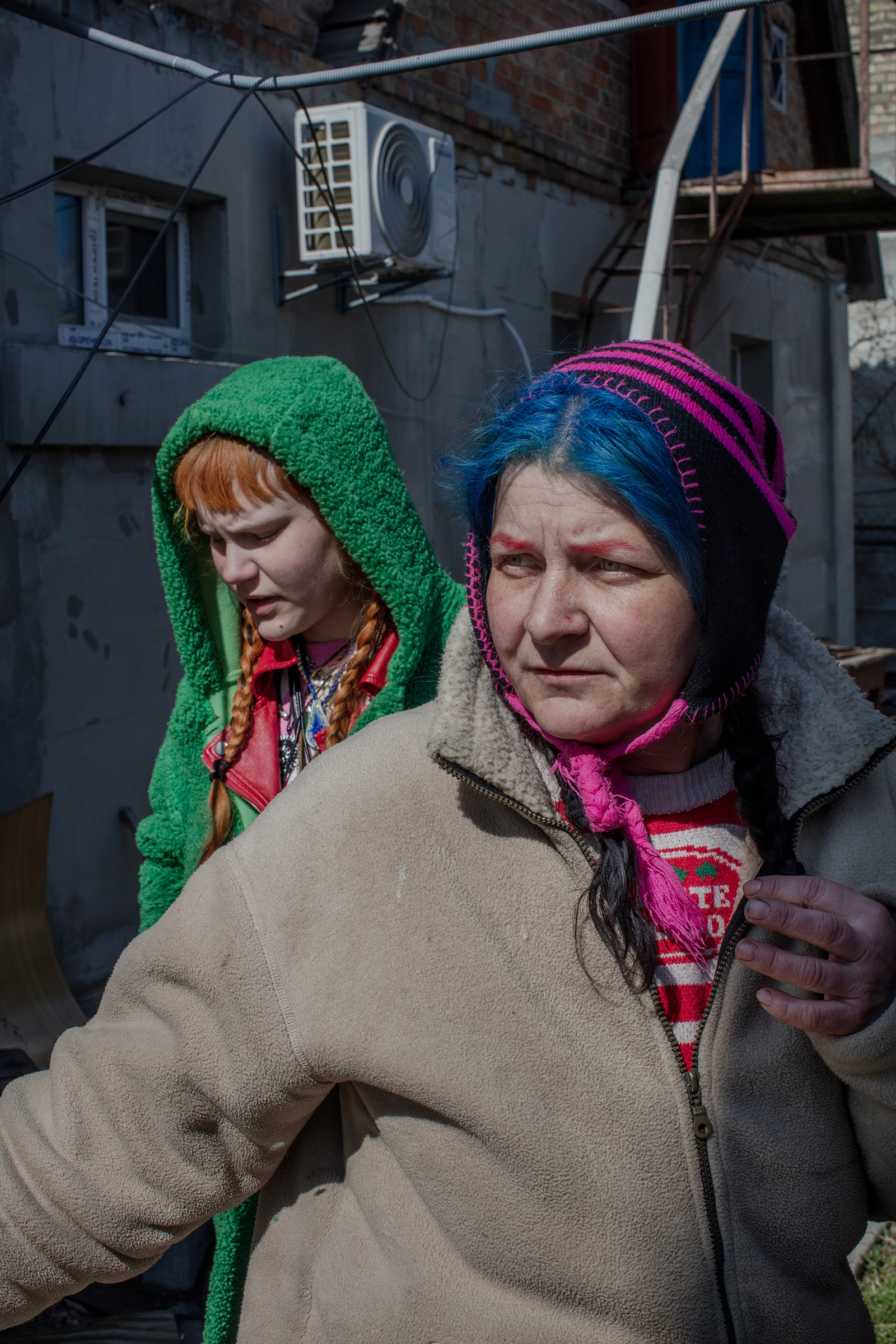 Gala and her daughter Veronika hid at home throughout the occupation in Bucha. Gala, with blue hair, said that the soldiers would come into her home twice a day threatening to kill them and terrorizing the neighborhood. (Natalie Keyssar)