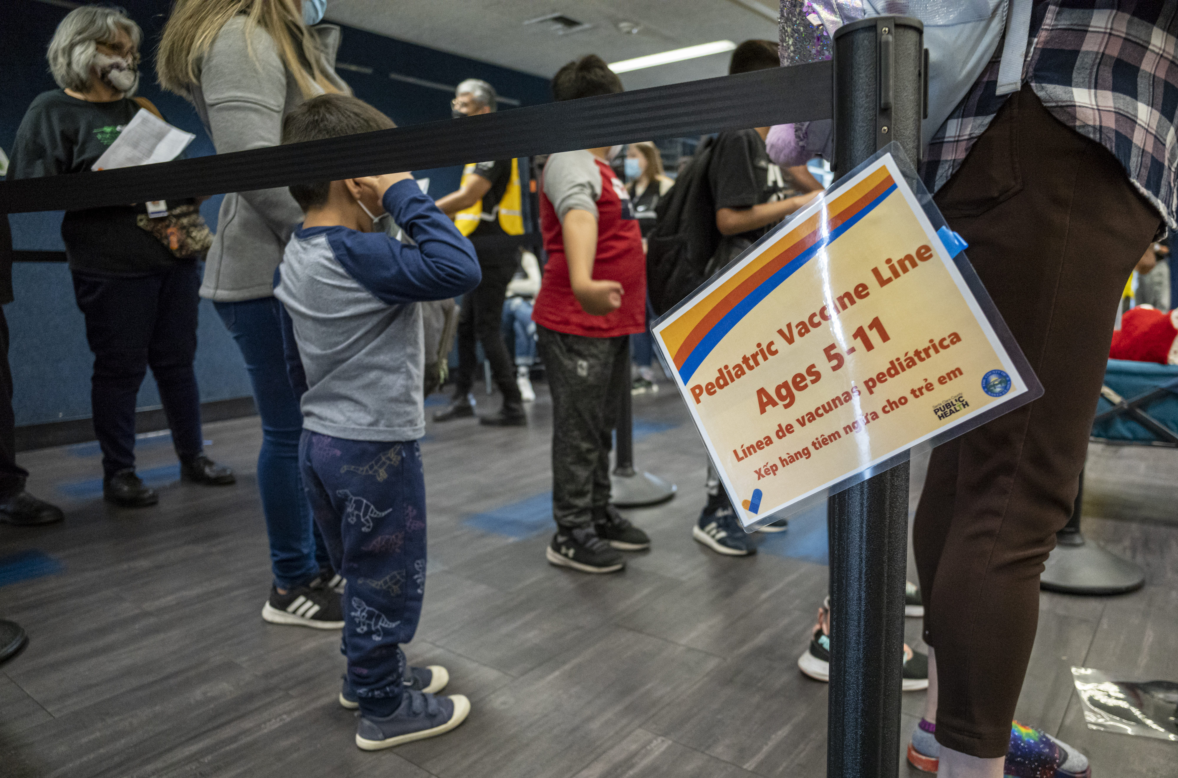 Children wait in line to receive a dose of the Pfizer-BioNTech COVID-19 vaccine at a vaccination clinic at an elementary school in San Jose, Calif., on Nov. 4, 2021. (David Paul Morris—Bloomberg/Getty Images)