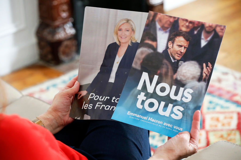 Official campaign posters of Marine Le Pen, leader of the far-right Rassemblement national (RN) party and French President Emmanuel Macron 'La République en marche' (LREM), candidates in the 2022 French presidential election on April 23, 2022 in Paris, France. (Photo illustration by Chesnot/Getty Images)
