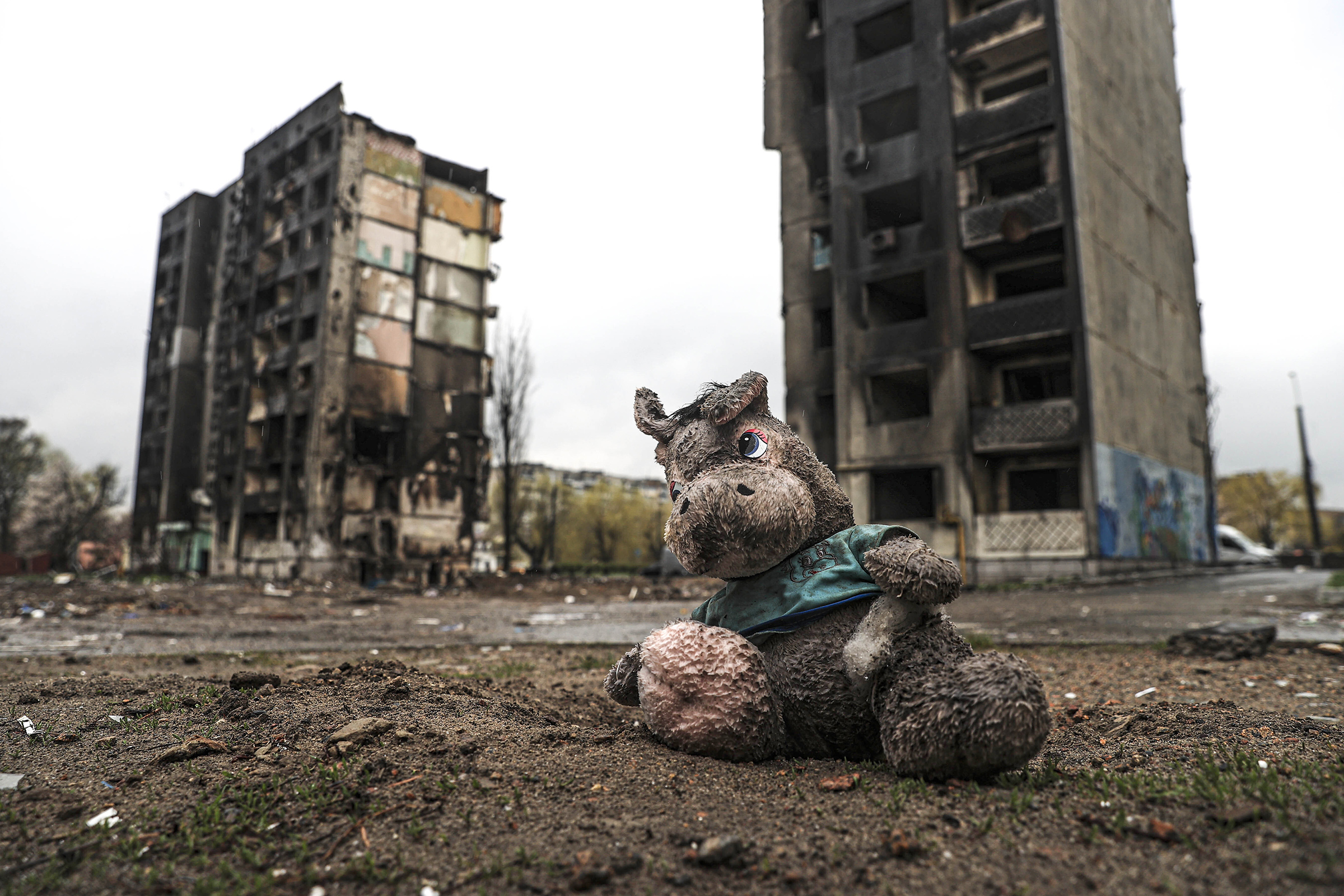 A muddy toy separated from a Ukrainian child is seen among the ruins of damaged buildings in Borodianka of Kyiv Oblast of Ukraine on April 22, 2022. (Metin Aktas—Anadolu Agency/Getty Images)