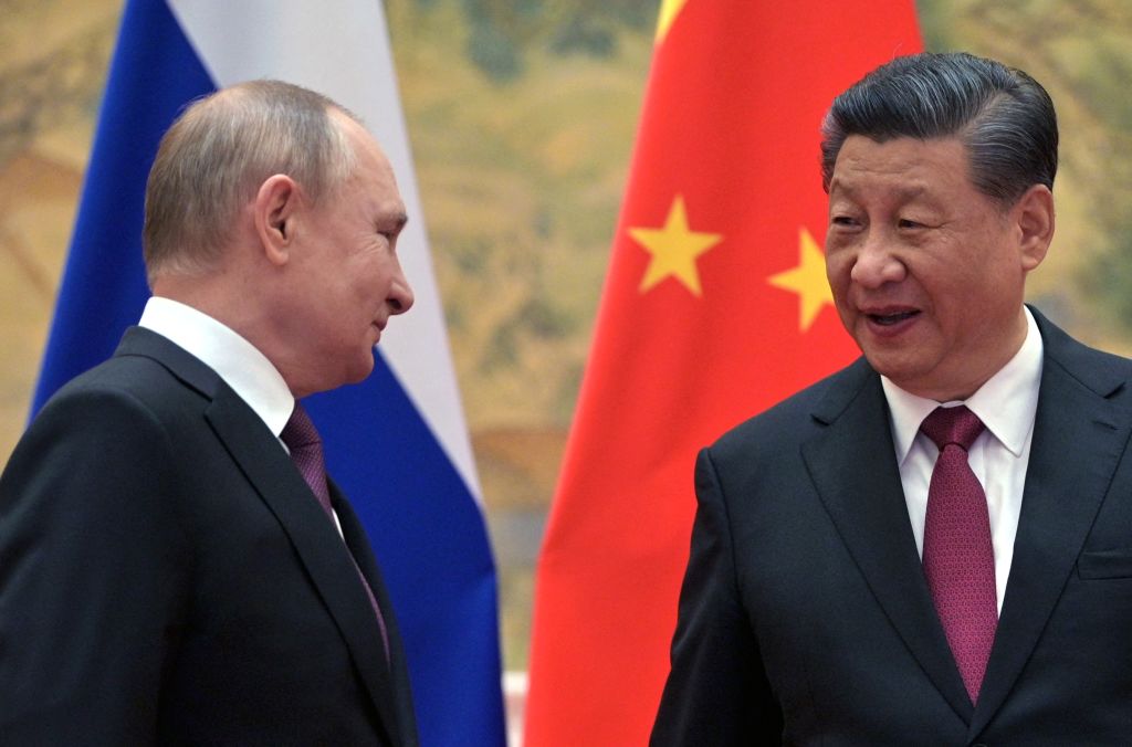 Russian President Vladimir Putin and Chinese President Xi Jinping arrive to pose for a photograph during their meeting in Beijing, on Feb. 4, 2022. (Alexei Druxhinin—Sputnik/AFP/Getty Images)