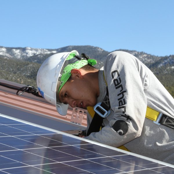 A GRID Alternatives tribal job trainee installs solar for the Picuris Pueblo tribe of New Mexico