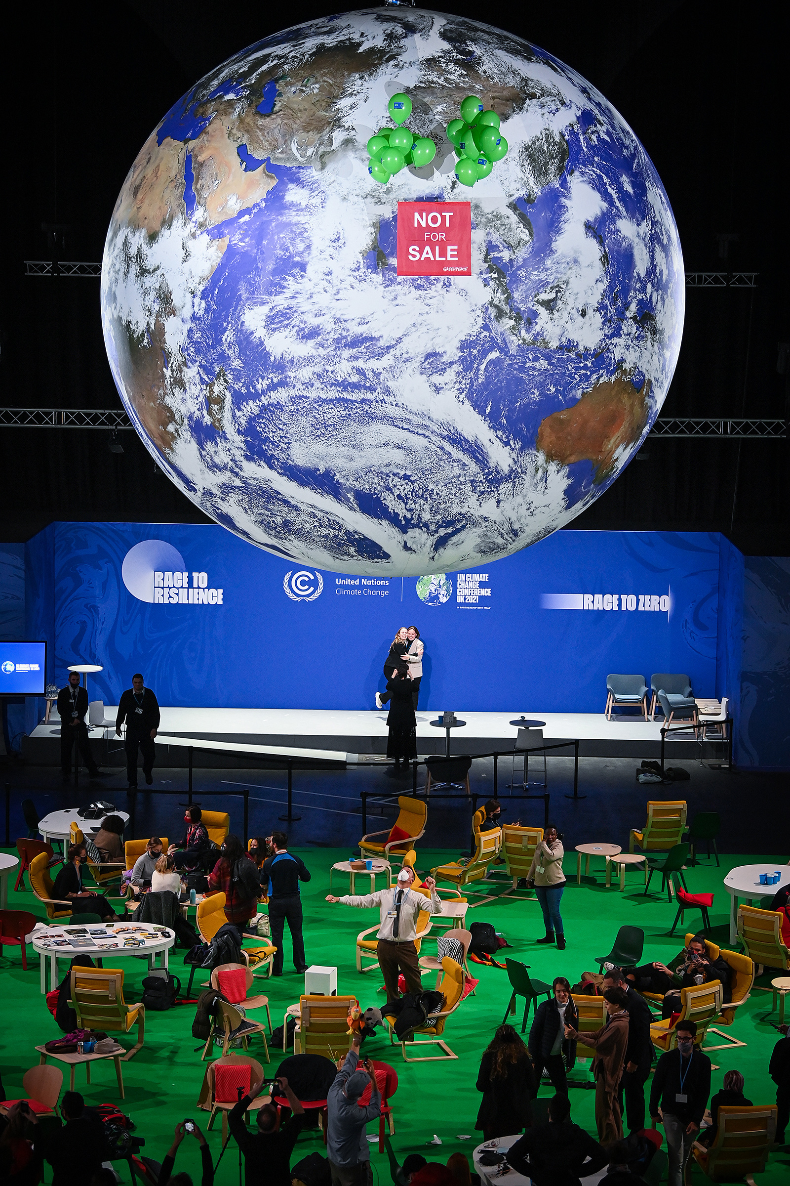 Greenpeace activists protest corporate involvement at the COP26 U.N. climate talks, in November 2021 (Jeff J Mitchell—Getty Images)