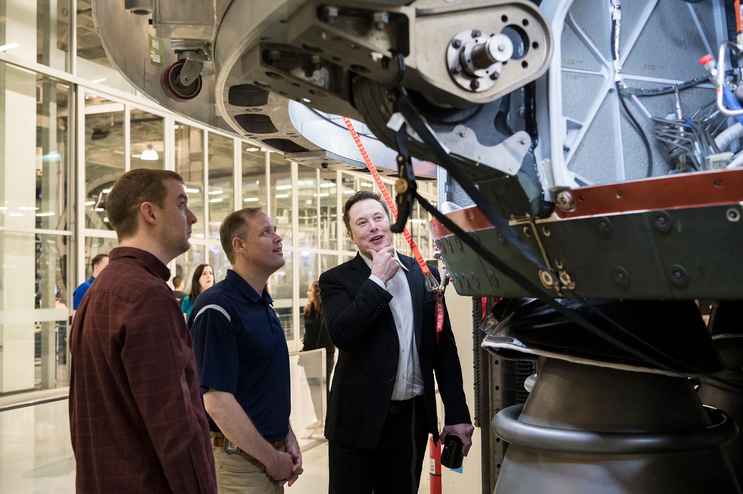 SpaceX Chief Engineer Elon Musk speaks with NASA Administrator Jim Bridenstine while viewing the OctaWeb, part of the Merlin engine used for the Falcon rockets, at the SpaceX Headquarters, in Hawthorne, Calif. on Oct. 10, 2019. (Aubrey Gemignani—NASA/Getty Images)
