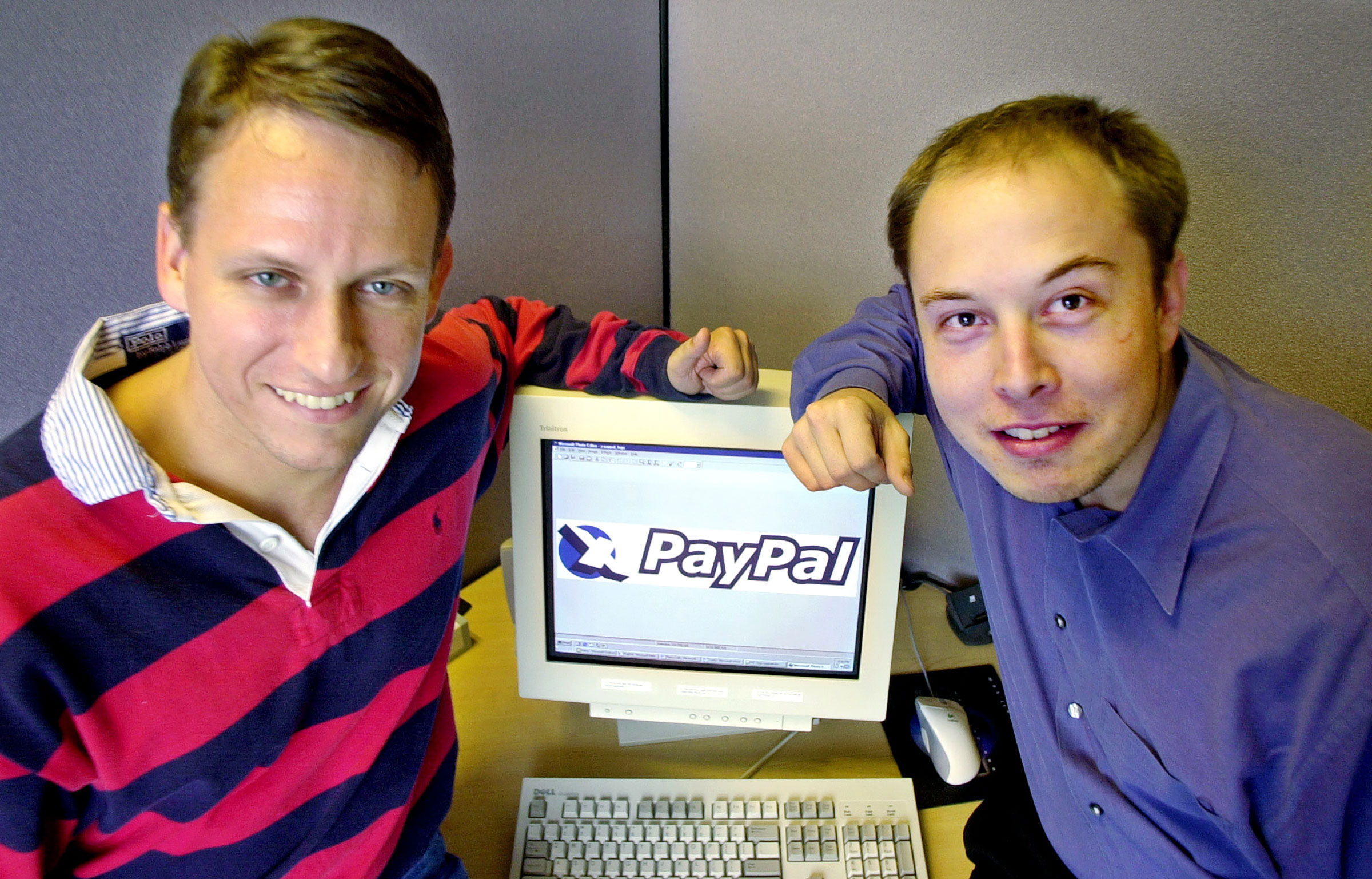 PayPal Chief Executive Officer Peter Thiel, left, and founder Elon Musk, right, pose with the PayPal logo at corporate headquarters in Palo Alto, Calif. on Oct. 20, 2000. (Paul Sakuma—AP)