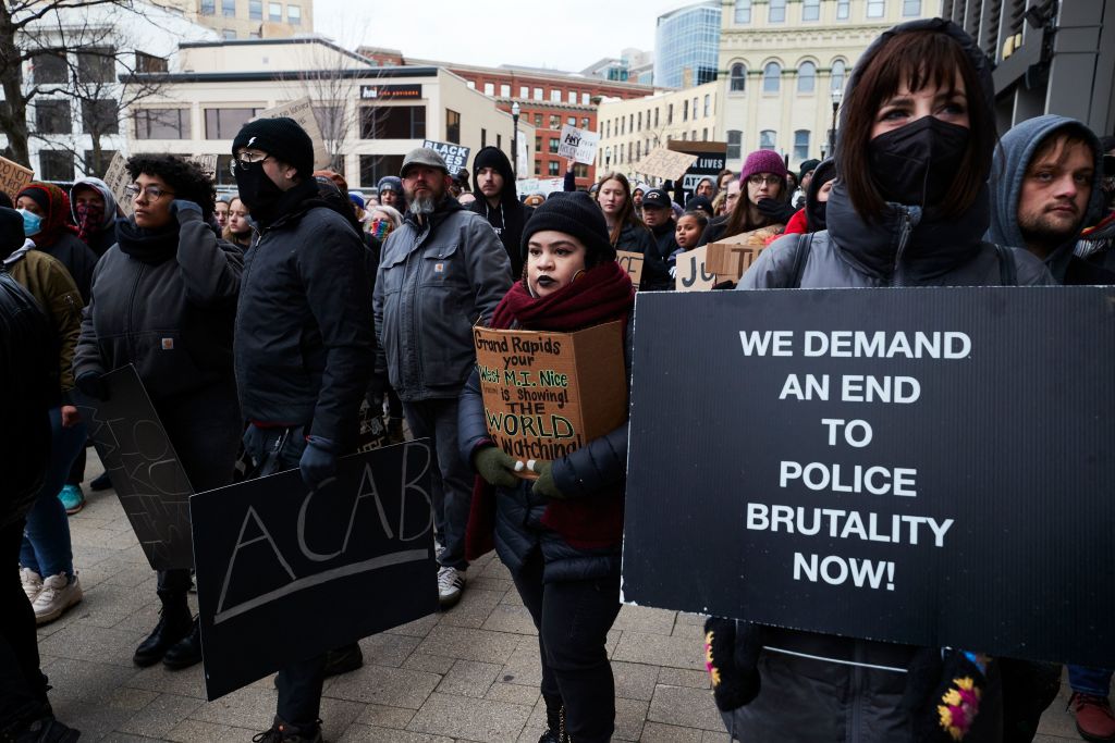 Protesters—including one whose sign references the idea of "Michigan Nice"—march for Patrick Lyoya, a Black man who was fatally shot by a police officer, in downtown Grand Rapids, Mich., April 16, 2022. (Mustafa Hussain—AFP/Getty Images)