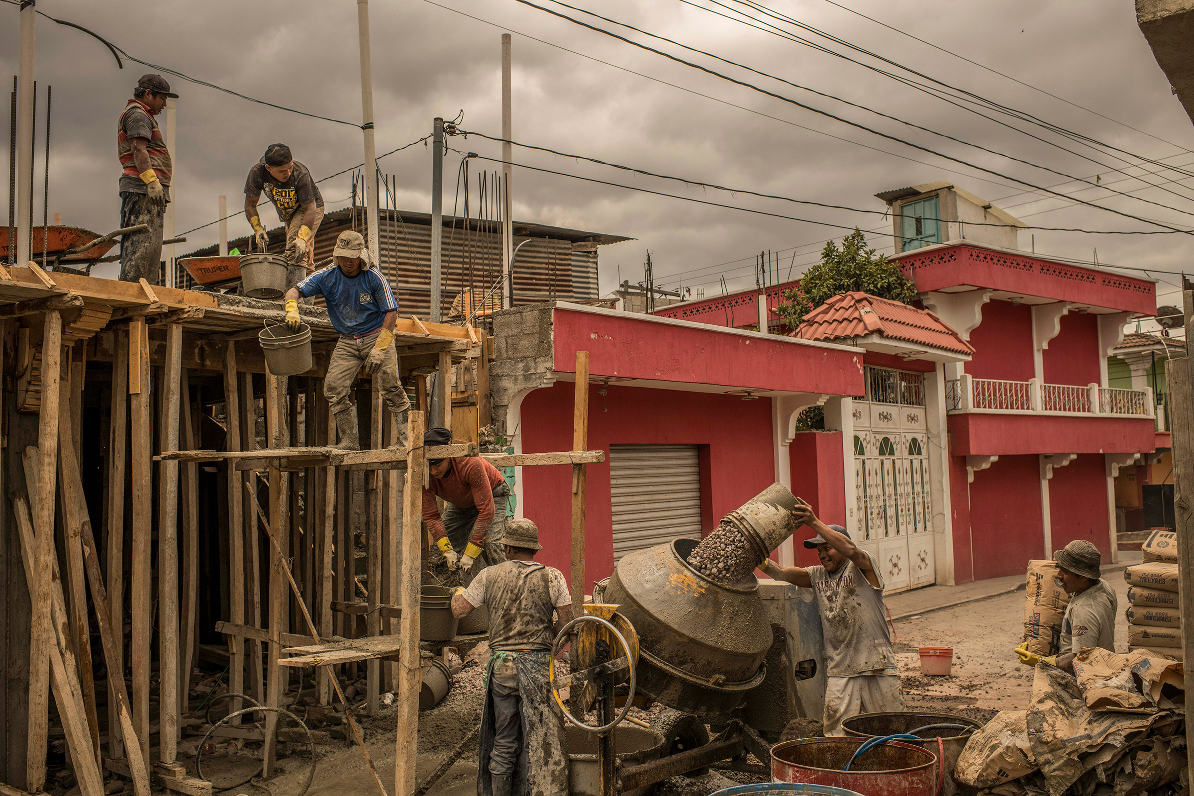 Workers build a house in Cajolá, Quetzaltenango, Guatemala, paid for by remittances. (Daniele Volpe for TIME)