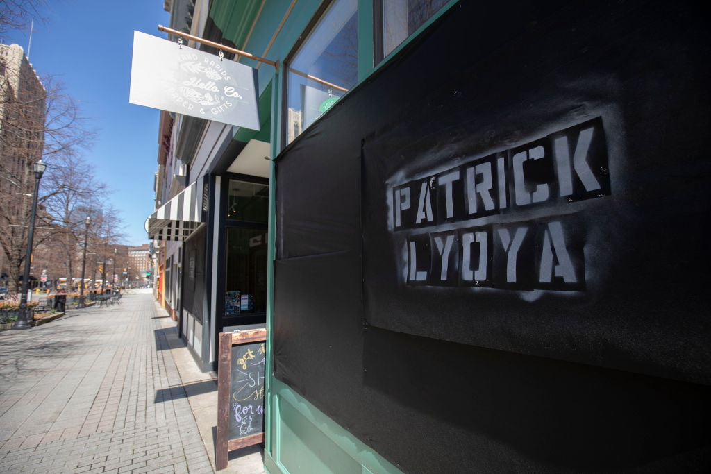 A banner with the name of Patrick Lyoya is shown on a store front on April 14, 2022, in Grand Rapids, Mich. Tensions are rising in the city following the release of videos that captured the shooting of Patrick Lyoya, a 26-year old Black man, who was shot and killed on April 4 by a Grand Rapids police officer following a traffic stop. (Bill Pugliano—Getty Images)