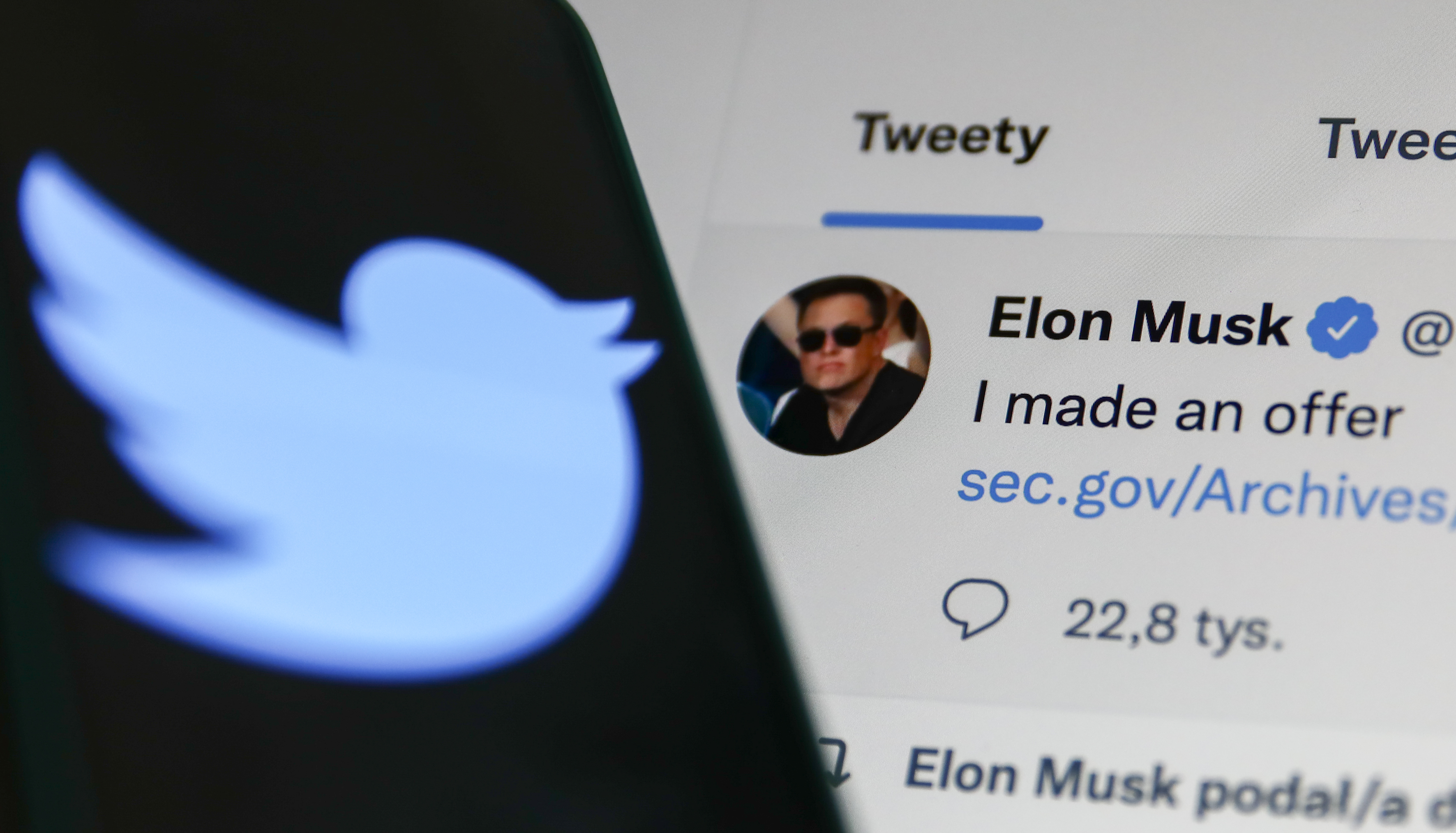 Elon Musk's Tweet displayed on a screen and Twitter logo displayed on a phone screen are seen in this illustration photo taken in Krakow, Poland on April 14, 2022. (Jakub Porzycki—NurPhoto/Getty Images)