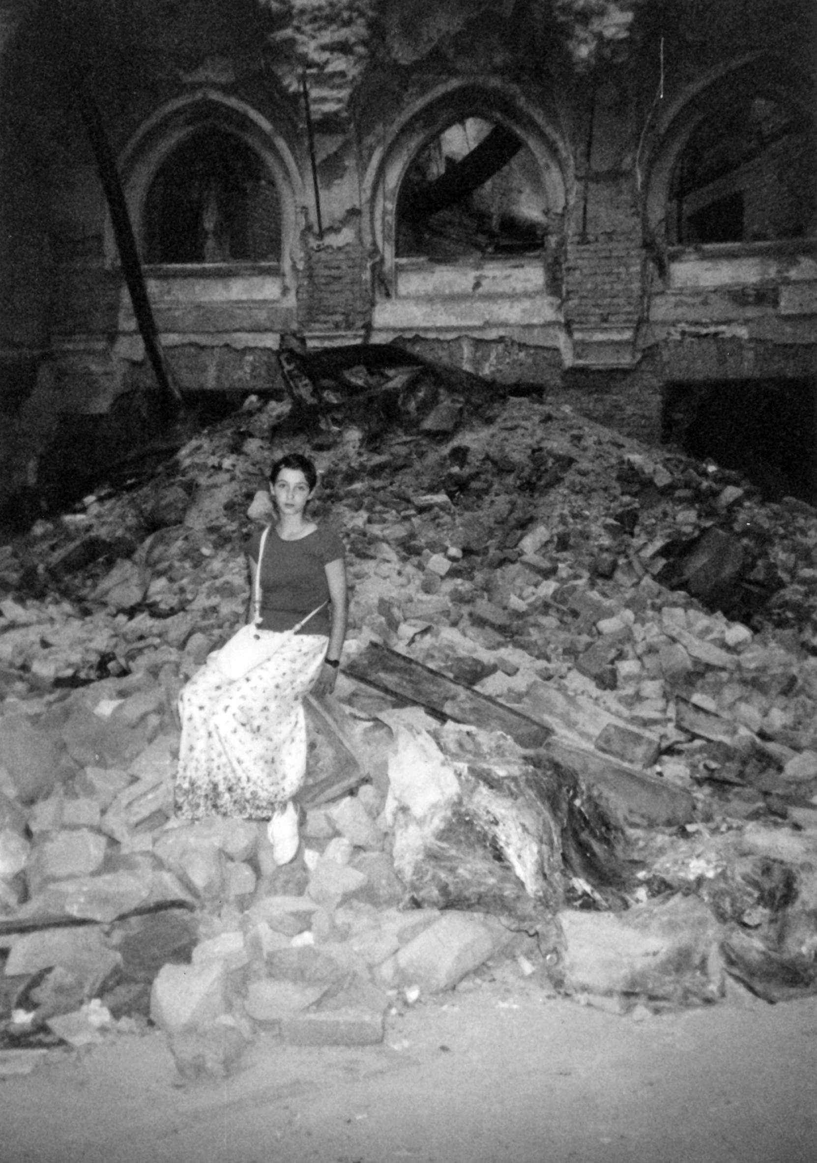 A young Nadja, sitting on the rubble of the National Library in Sarajevo.