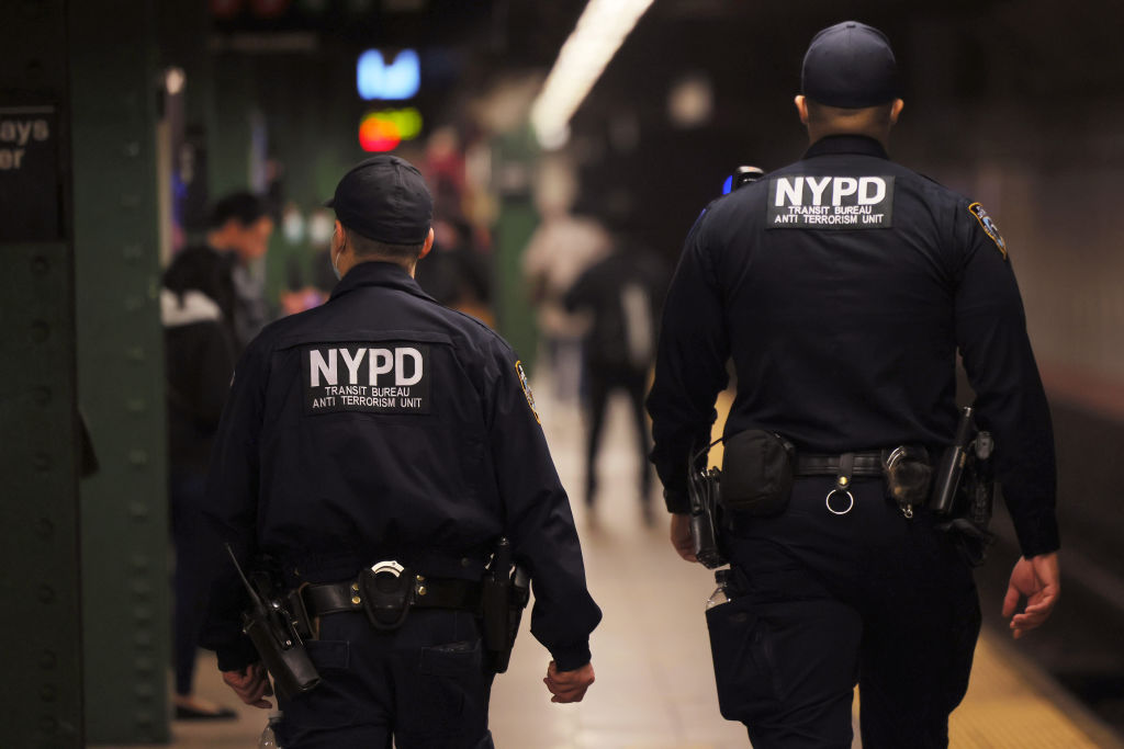 NYPD officers patrol a subway platform at  on April 13, 2022, in Brooklyn in New York City, as a manhunt was underway for the gunman who opened fire during the previous morning's rush hour (Michael M. Santiago—Getty Images)