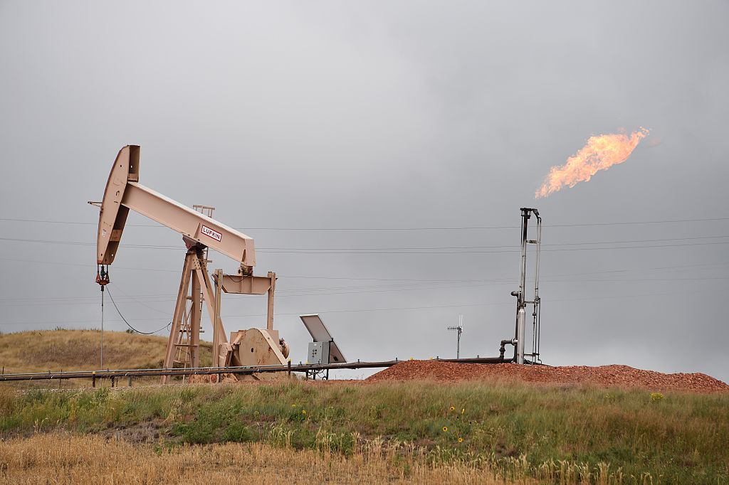 Pump jacks and a gas flare are seen near Williston, North Dakota, on September 6, 2016. (ROBYN BECK/AFP—Getty Images)