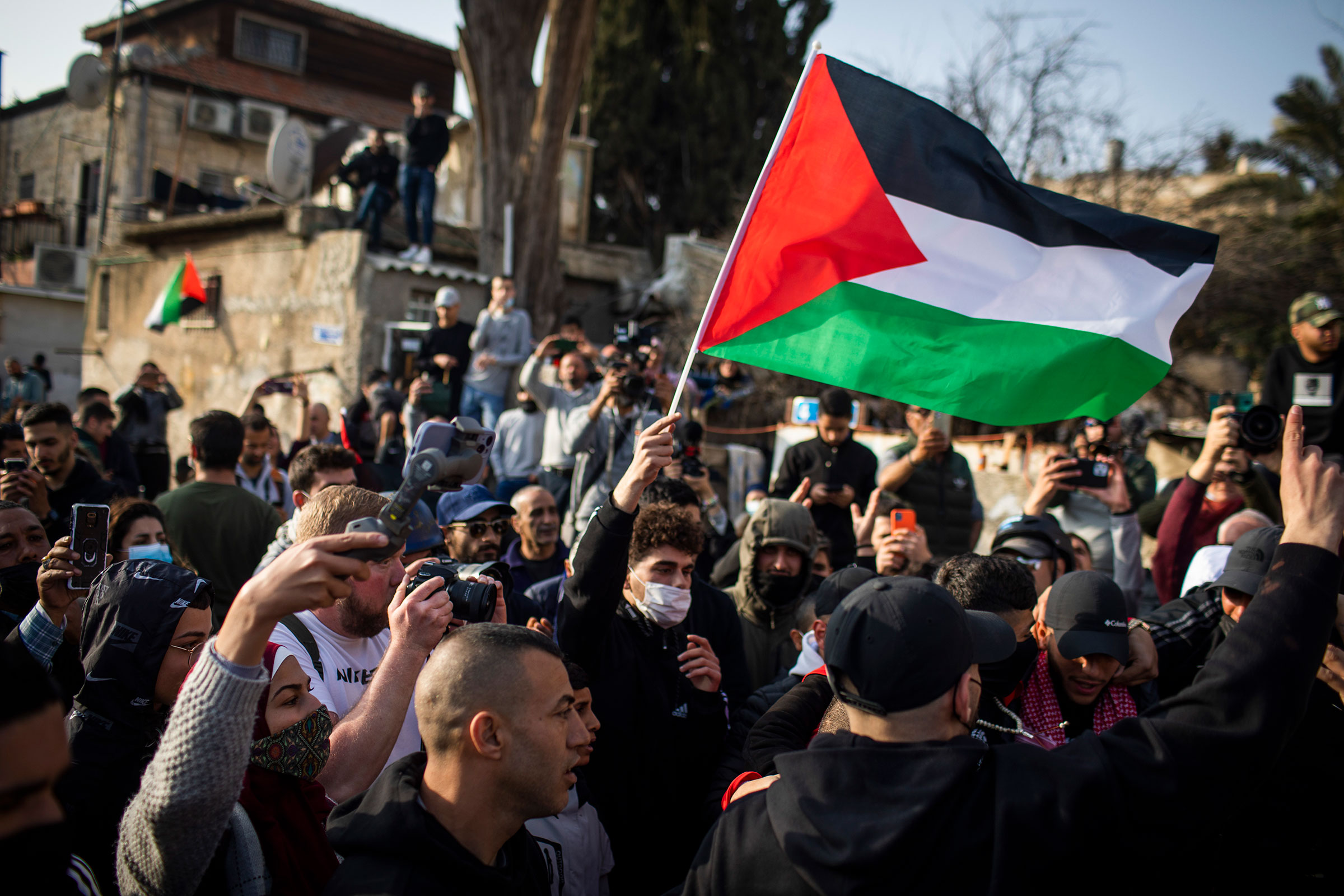 Palestinian and Israeli activists take part in a weekly protest in the East Jerusalem neighborhood of Sheikh Jarrah, against the eviction of Palestinian families in favor of Jewish settlers, on Feb. 18, 2022. (Ilia Yefimovich—picture alliance/Getty Images)