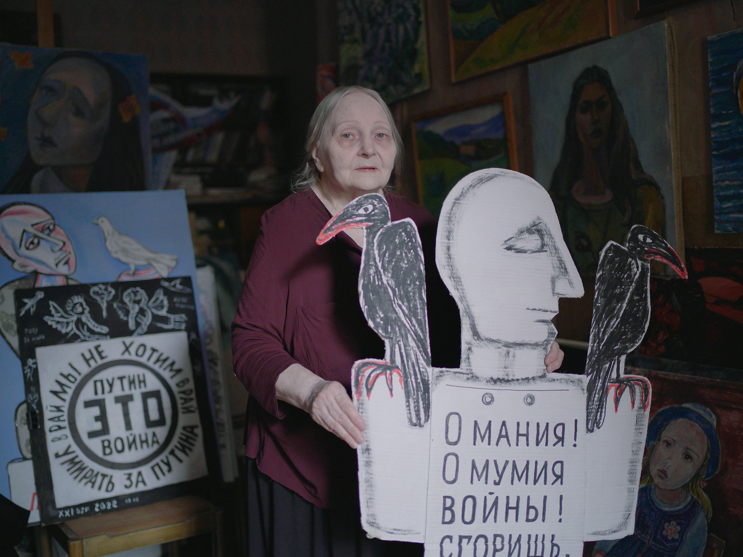 Portrait of Yelena at her home in Saint Petersburg, Russia, 28 March 2022Elena Osipova, visual artist, 77 . She has been protesting on the streets of St. Petersburg with her political posters for 20 years. Many people call her the "conscience of St. Petersburg". «I am a post-war child and my family survived the Siege of Leningrad. I have been going out to protest since 2002, after terrorist attack on Dubrovka in Moscow during the musical «Nord-Ost». I went out for the first time with a one-man picket to the Mariinsky Palace in St. Petersburg. People just looked at me, but no one came around. After that I decided to paint posters as an artist and share my views this way. Next four years I went out with political posters. People passing by didn't want to look and read that. But that's never stopped me. After a while I was standing with another active group of people. I felt changes because youths’ growing interest in politics. I saw many people who demanding changes and working on that. I saw many protests in Russia, the government has not really done anything for our country development in 20 years. And now they have started the war. 24 of February I got a night call from a Moscow journalist who asked me to comment on this situation. I said: «Russian fuhrer comes to Anschluss». I have been on protests since 2014 and painted posters against war, but I didn't expect it to happen on such a scale. I was arrested by police many times. They demanded me disappear and stay aside I'm afraid of aggressive so called titushki* more than police now. They pursue me from my home and get aggressive when I showed my posters on the street. I was ashamed of their actions. I'm hoping for a change of power. Bulat Okudzhava, a Soviet poet, died without hope for humanity. I still hope and go out with posters against this "special military operation" as long as my health allows. I am glad to see a lot of modern people who protests and speak out against this nightmare