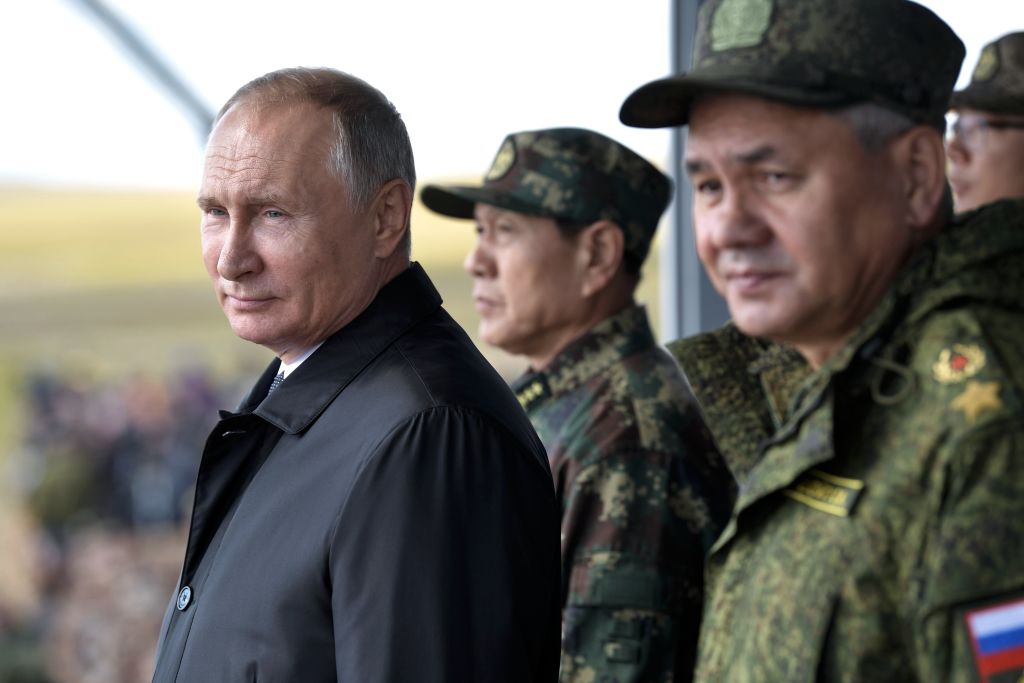 Russia's President Vladimir Putin, China's Defense Minister Wei Fenghe, and Russian Defence Minister Sergei Shoigu watch the parade of the participants of the Vostok-2018 (East-2018) military drills at Tsugol training ground not far from the Chinese and Mongolian border in Siberia, on September 13, 2018. (Alexey Nikolsky—AFP/Getty Images)