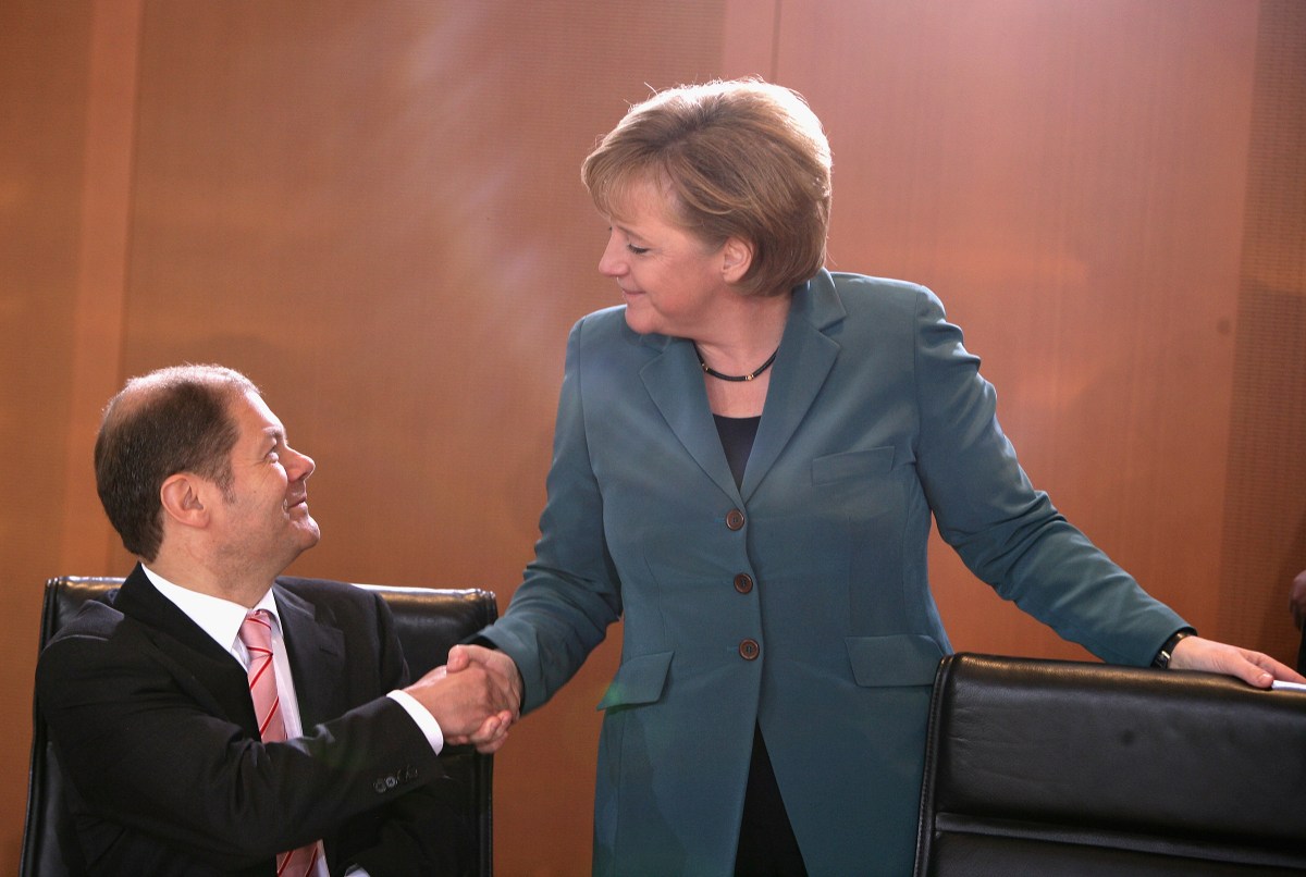 German Chancellor Angela Merkel welcomes Scholz during a cabinet meeting on Jan. 9, 2008, in Berlin