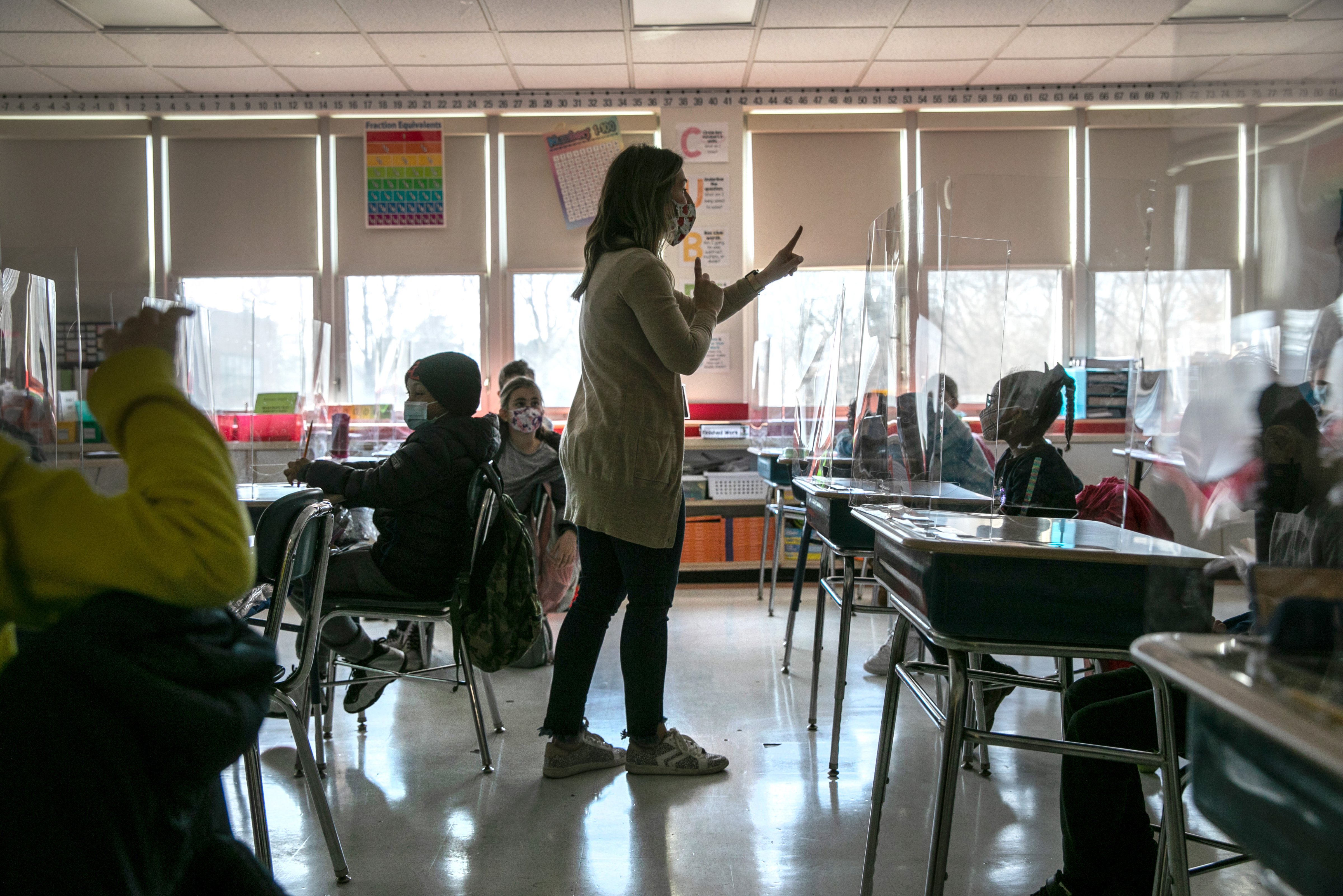 Third-grade literacy instructor Katelyn Battinelli talks with students about their pandemic-related fears on the first day of in-person learning for five days per week at Stark Elementary School on March 10, 2021, in Stamford, 
                      Conn. (John Moore—Getty Images)