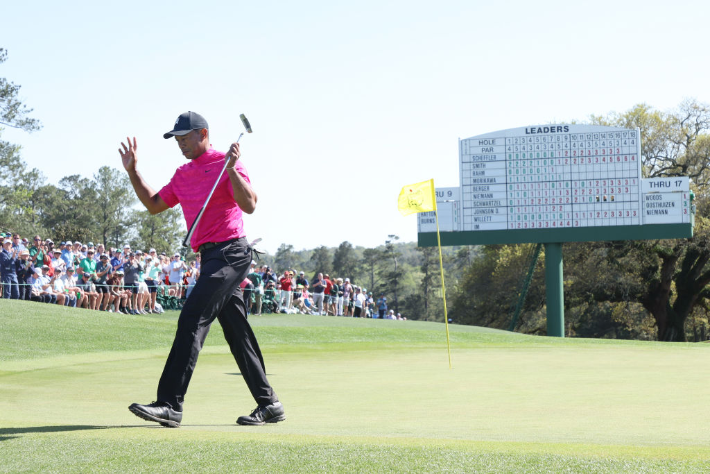 Tiger Woods waves to the crowd while walking off the 18th green after finishing his round during the first round of the Masters at Augusta National Golf Club on April 07, 2022 in Augusta, Georgia. (Jamie Squire—Getty Images)