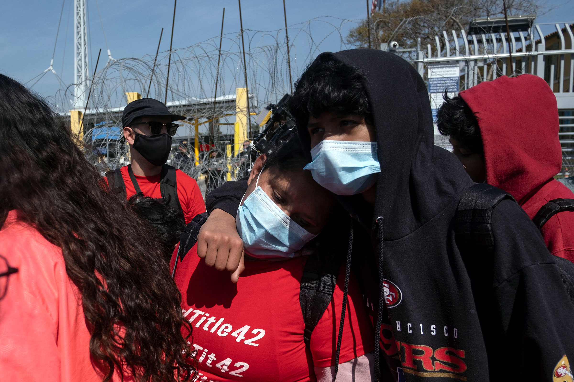Asylum seekers react after been rejected at the border during a protest against Title 42 policy on the Mexican side of the San Ysidro Crossing port in Tijuana, Baja California state, Mexico, on March 21, 2022. (Guillermo Arias—AFP/Getty Images)