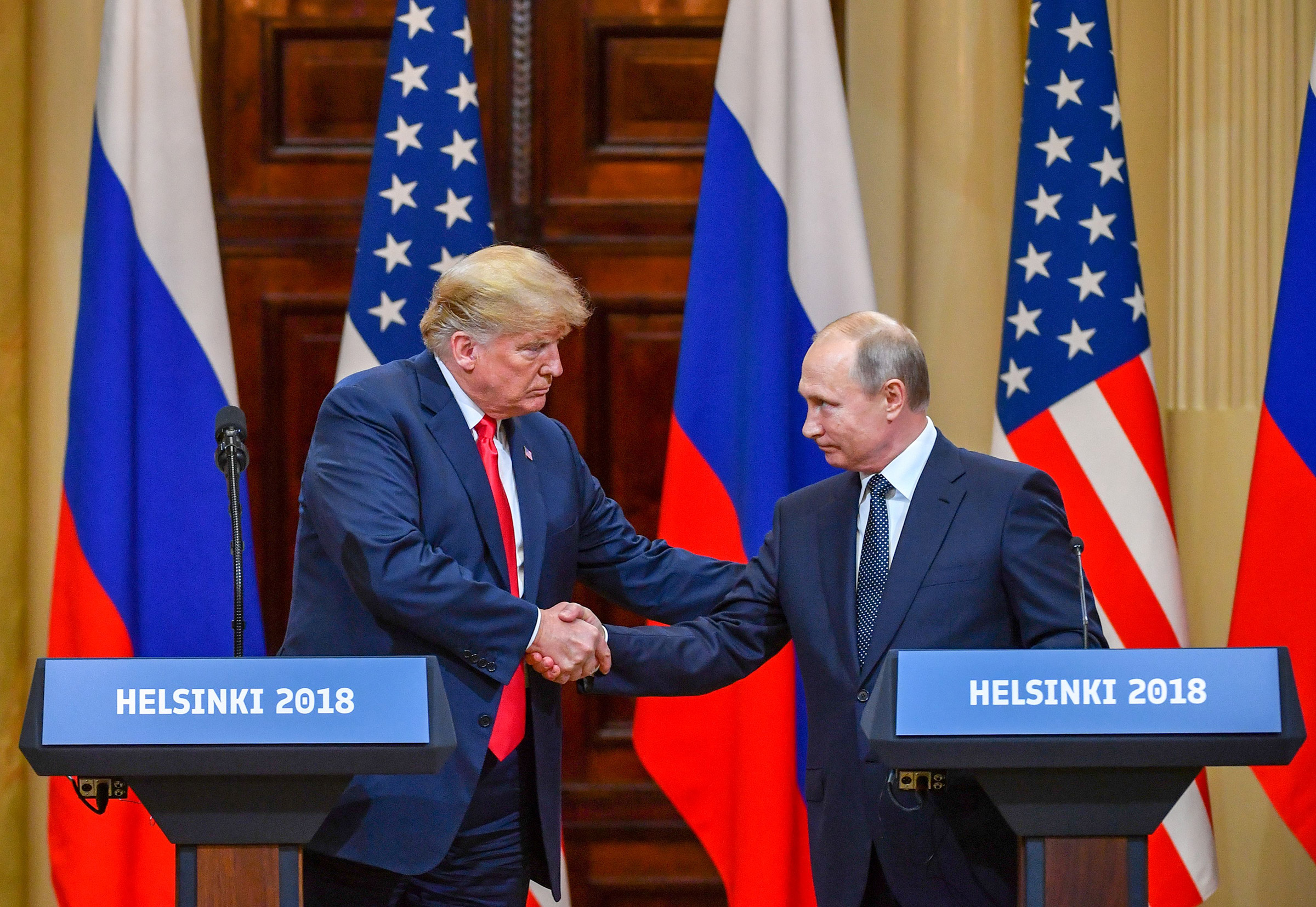 U.S. President Donald Trump and Russia's President Vladimir Putin shake hands before attending a joint press conference in Helsinki, on July 16, 2018. (Yuri Kadobnov—AFP/Getty Images)