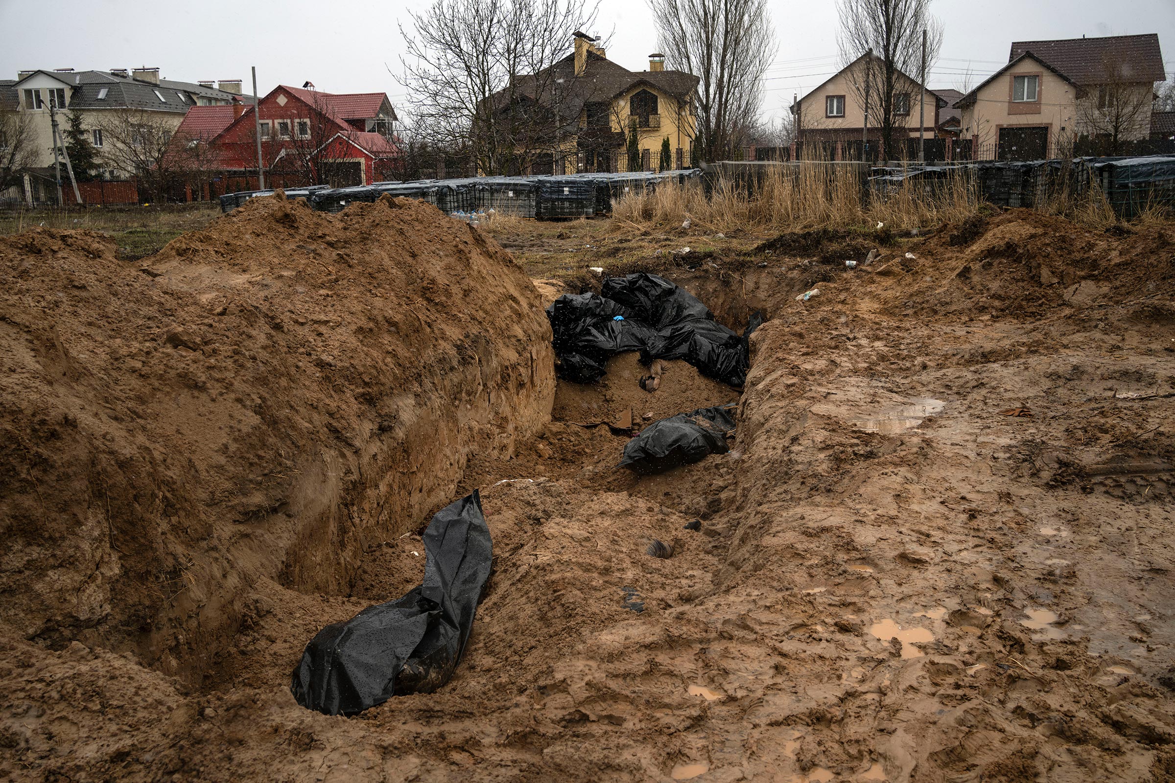 Bodies lie in a mass grave in Bucha, Ukraine, April 3, 2022.