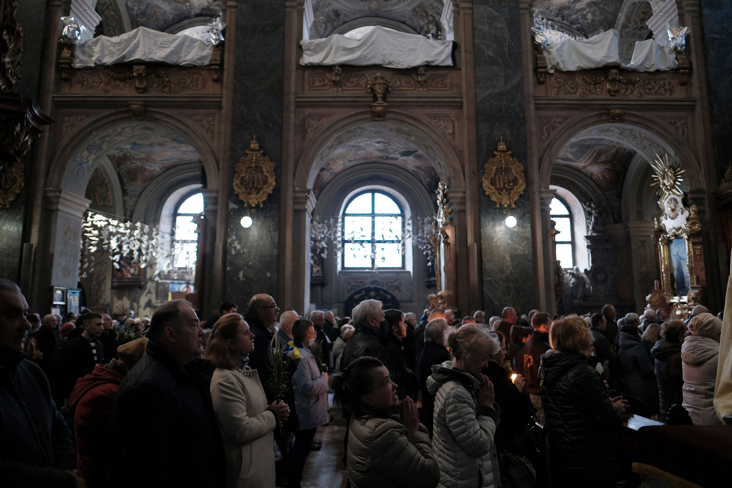 Local citizens attend a worship on Sunday before Easter at the Orthodox Church of Ukraine in Lviv, western Ukraine on April 17, 2022. (Hiroto Sekiguchi—The Yomiuri Shimbun/AP)
