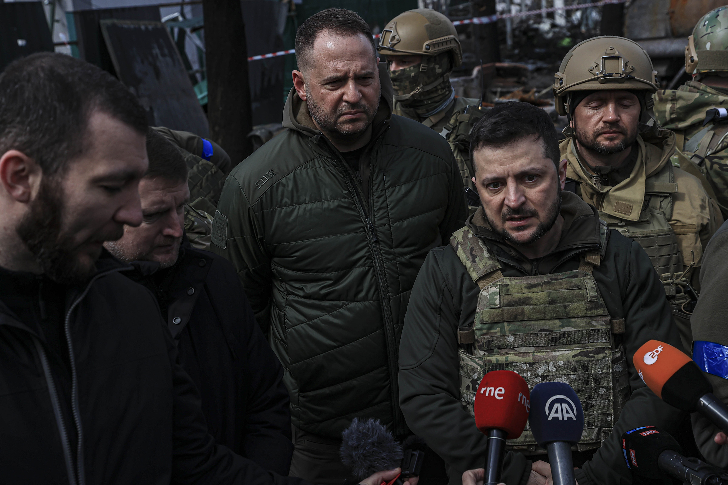 Zelensky, with his chief of staff Andriy Yermak, center, speaks to journalists in Bucha on April 4 (Metin Aktas—Anadolu Agency/Getty Images)
