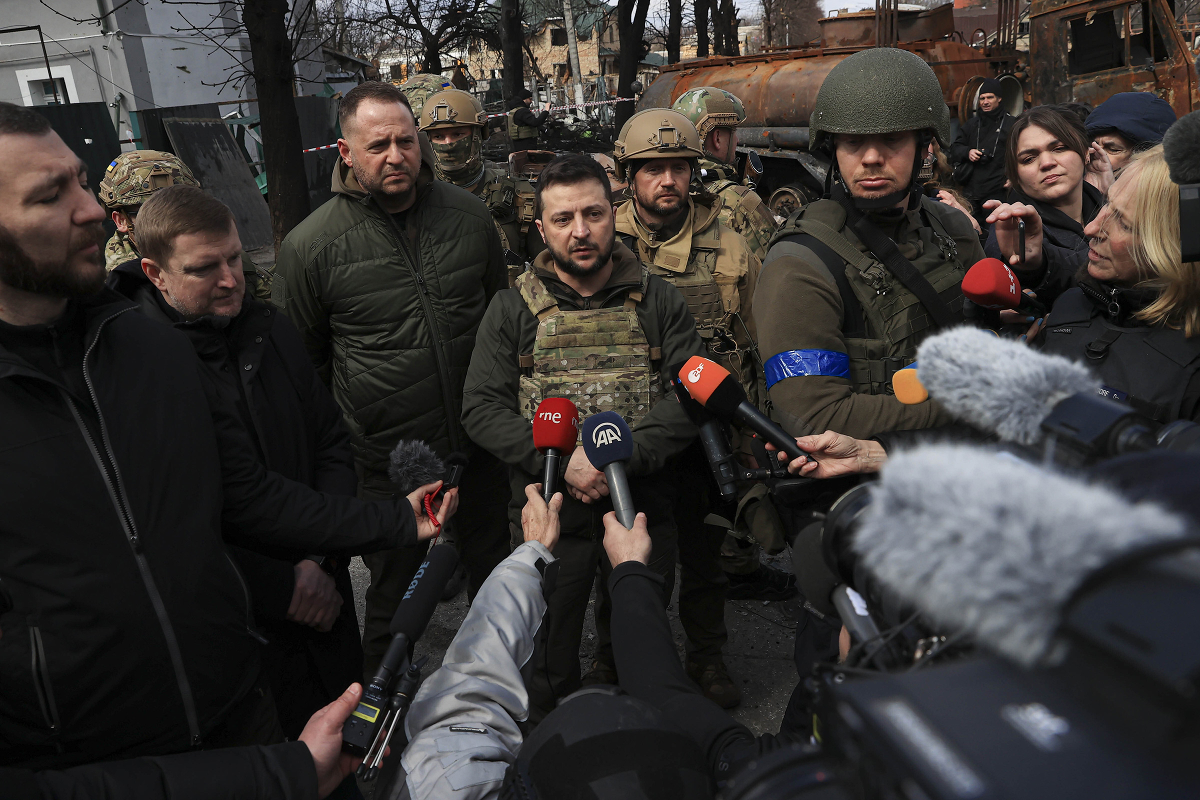 Zelensky, with his chief of staff Andriy Yermak, center, speaks to journalists in Bucha on April 4 (Metin Aktas—Anadolu Agency/Getty Images)