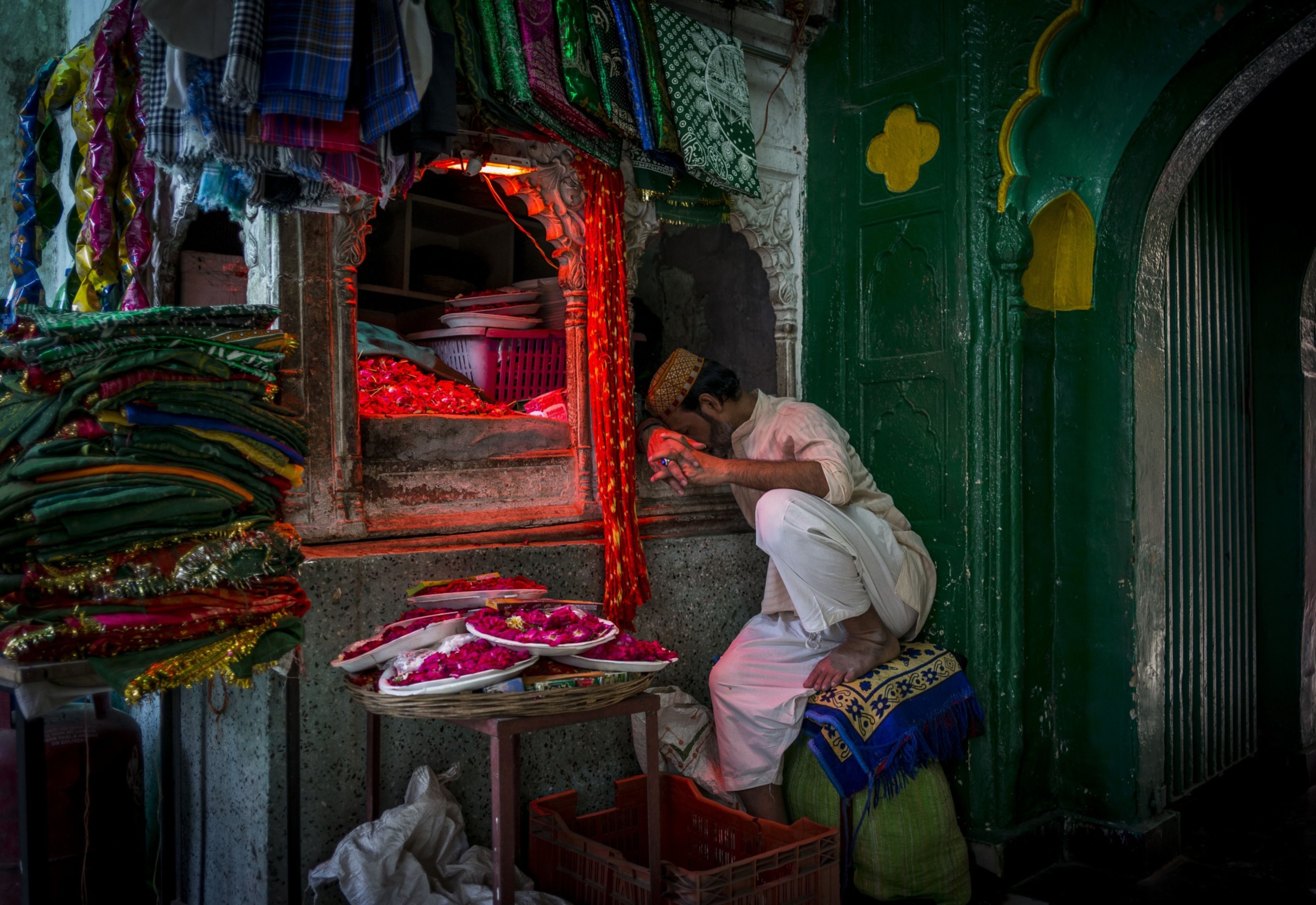 A florist naps on a hot summer afternoon in New Delhi on April 30, 2022. (Anindito Mukherjee/Bloomberg)