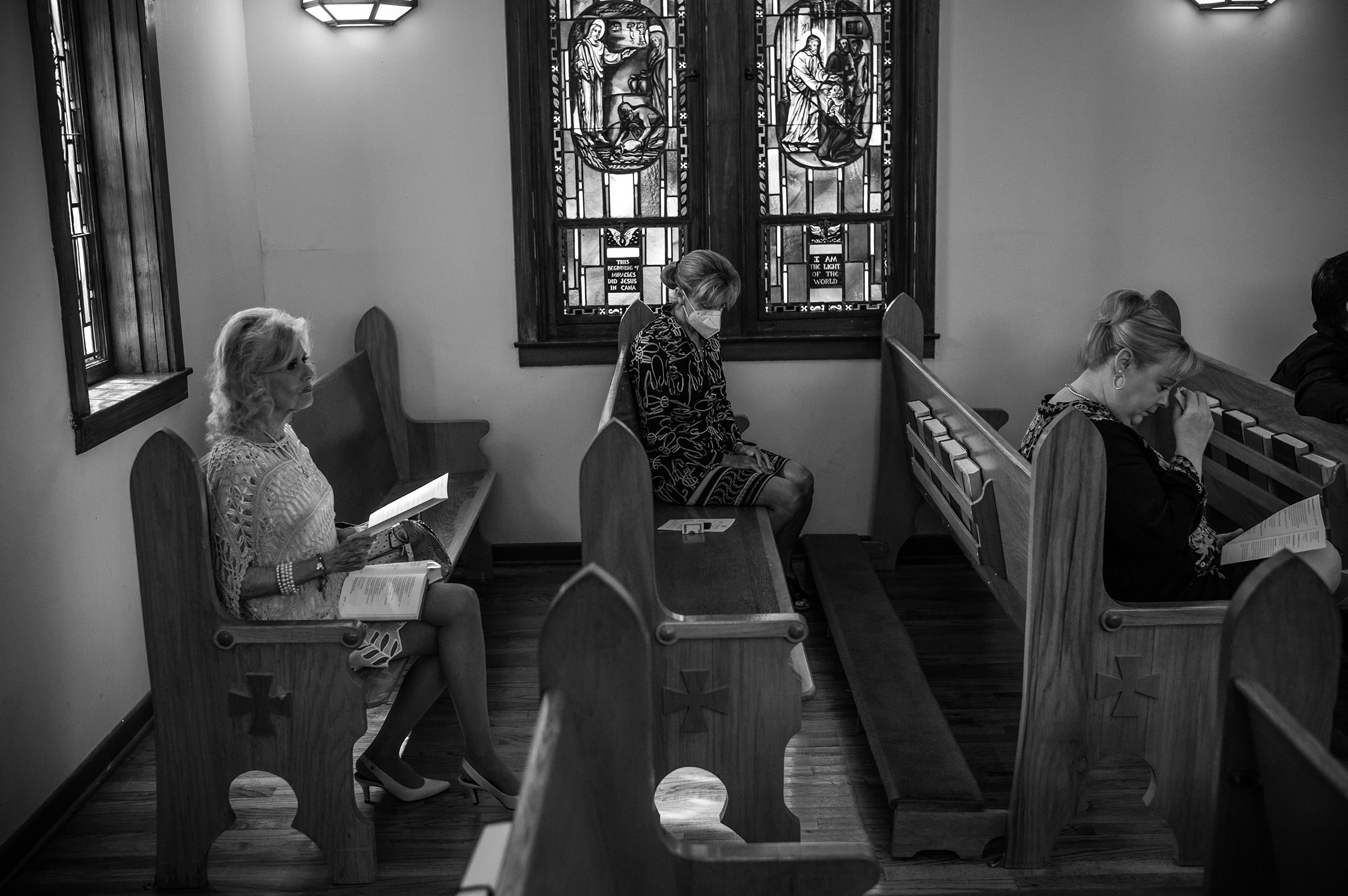 Three woman listen to a sermon at St. Philip's Episcopal Church on May 29, 2022. (David Butow for TIME)