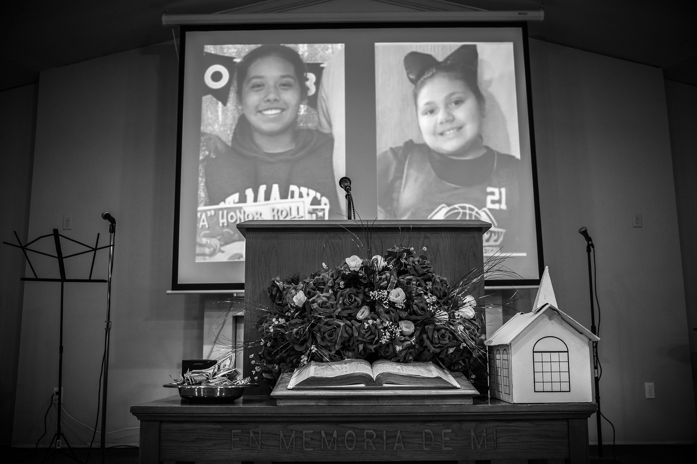 The photographs of Lexi Rubio, left, and Eliahna Garcia, students at Robb Elementary school who were killed in the recent mass shooting are projected during a service at Iglesia Bautista church on May 29, 2022. (David Butow—Redux)