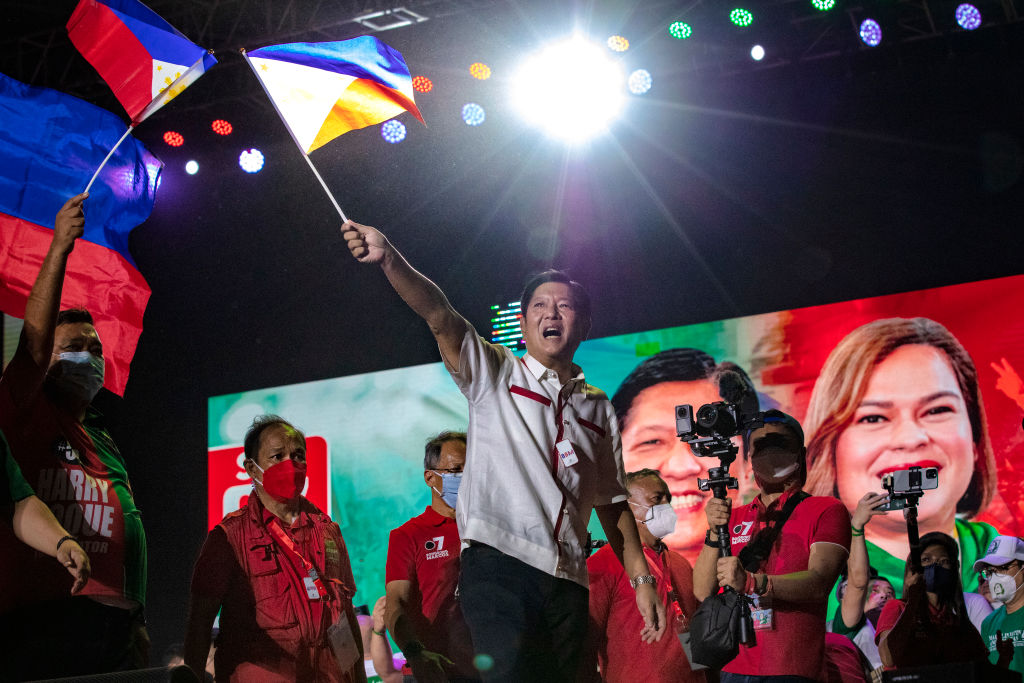 Ferdinand 'Bongbong' Marcos Jr. waves a Philippine flag during his last campaign rally before the election on May 7, 2022. (Ezra Acayan–Getty Images)