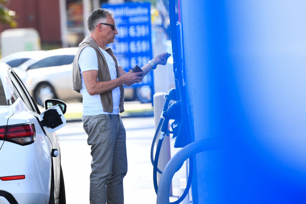 A customer uses a credit card to pump gas at a Mobil gas station  in Los Angeles on April 28, 2022. High fuel prices have contributed to windfall profits for fossil fuel companies. (Patrick T. Fallon—AFP/Getty Images)
