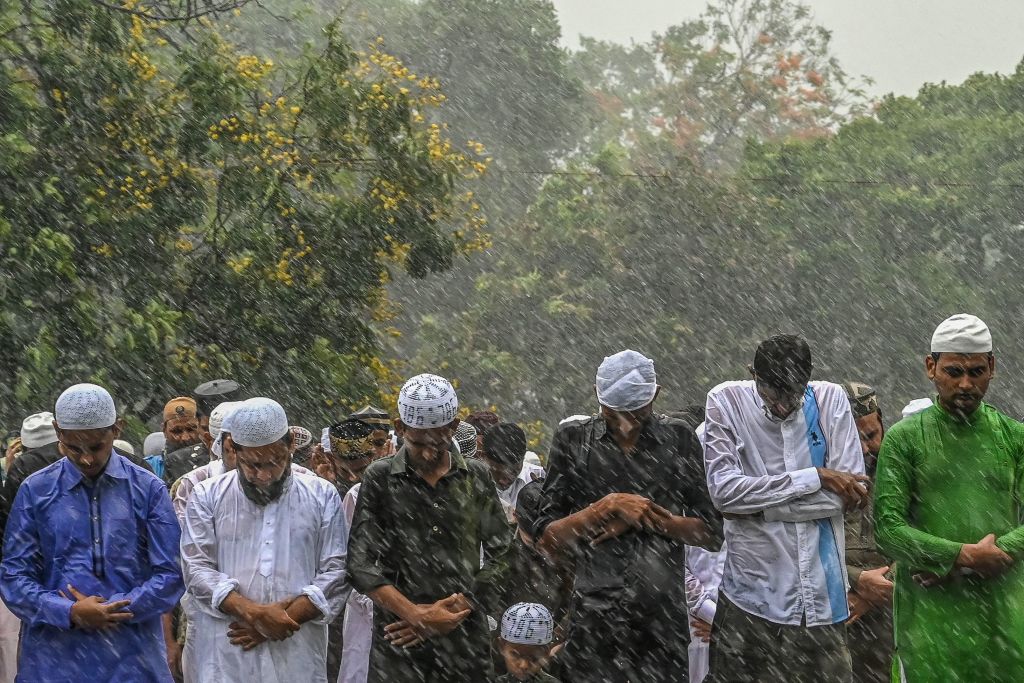 Muslims offer morning prayers amid drizzle, to start the Eid al-Fitr festival, which marks the end of the holy fasting month of Ramadan, Red Road, Kolkata, May 3, 2022. (Dibyangshu Sarkar—AFP/Getty Images)