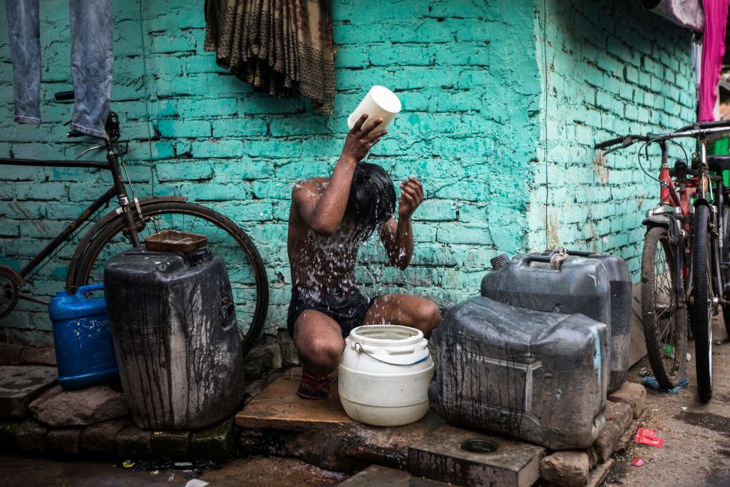 A boy bathes during a hot summer day in New Delhi on May 3, 2022. (XAVIER GALIANA/AFP via Getty Images)