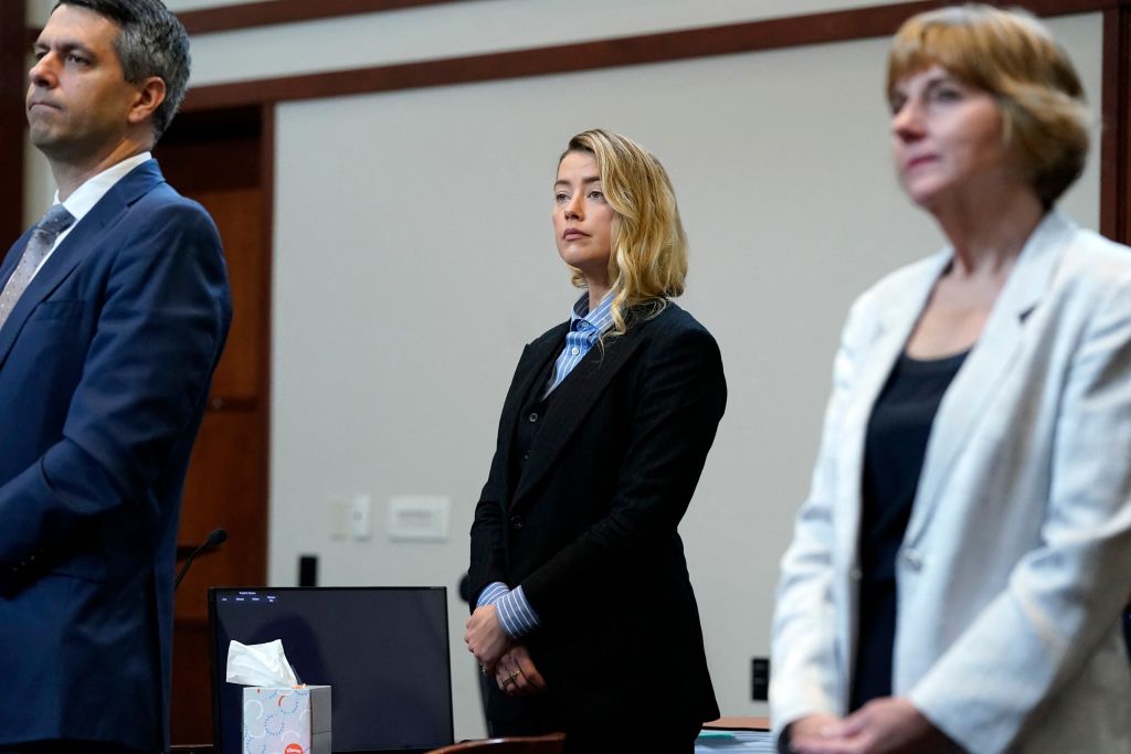 US actress Amber Heard (C) stands in the courtroom with her legal team at the Fairfax County Circuit Court, during a defamation case against her by ex-husband, US actor Johnny Depp, in Fairfax, Virginia, on May 4, 2022. - US actor Johnny Depp sued his ex-wife Amber Heard for libel in Fairfax County Circuit Court after she wrote an op-ed piece in The Washington Post in 2018 referring to herself as a "public figure representing domestic abuse." (Elizabeth Frantz—Getty Images)