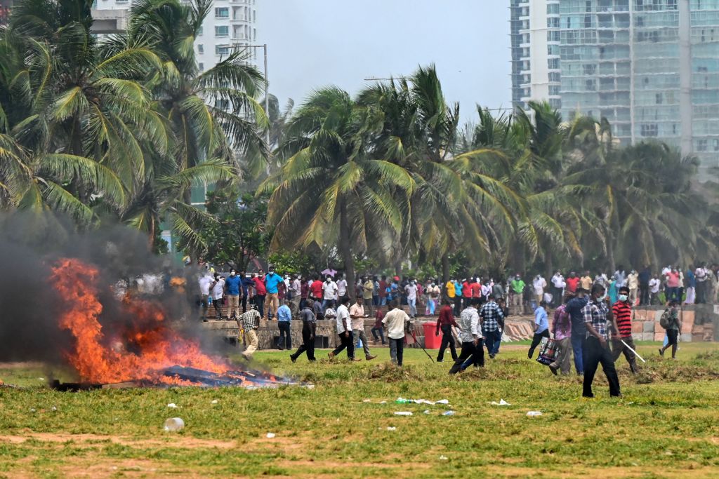 Demonstrators and government supporters clash outside the President's office in Colombo on May 9, 2022. — Police imposed an indefinite curfew in Sri Lanka's capital on May 9 after government supporters clashed with demonstrators demanding the resignation of President Gotabaya Rajapaksa. (ISHARA S. KODIKARA/AFP—Getty Images)