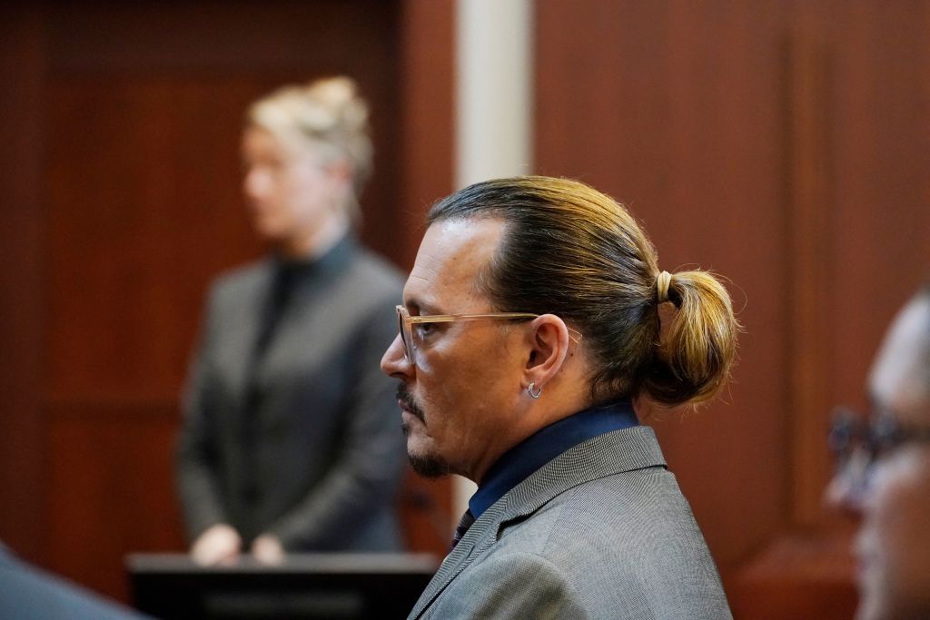 Actors Amber Heard and Johnny Depp watch as the jury comes into the courtroom after a break at the Fairfax County Circuit Courthouse in Fairfax, Va., on May 16, 2022. (Photo by Steve Helber / POOL / AFP) (Photo by STEVE HELBER/POOL/AFP via Getty Images) (POOL/AFP via Getty Images)
