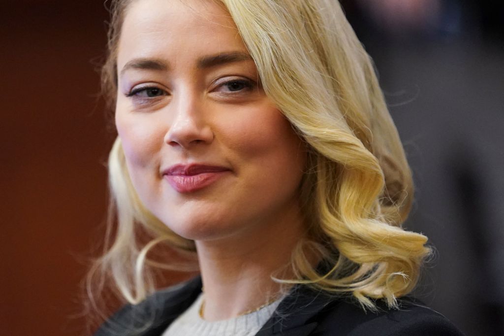 Actor Amber Heard smiles during a defamation case against her by ex-husband, actor Johnny Depp, at the Fairfax County Circuit Courthouse in Fairfax, Virginia, on May 18, 2022. (Kevin Lamarque—Getty Images)