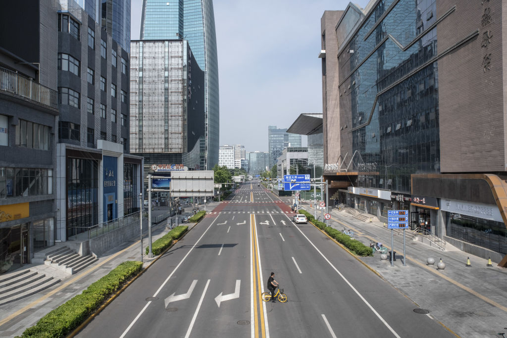 A cyclist rides across a near-empty road in Beijing, China, on Monday, May 23, 2022. (Bloomberg via Getty Images—© 2022 Bloomberg Finance LP)