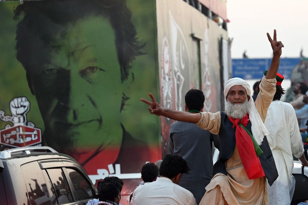 A supporter of ousted Pakistan's prime minister Imran Khan flashes the victory sign as they march along a street during a demonstration in Islamabad on May 26, 2022. (AAMIR QURESHI/AFP via Getty Images)